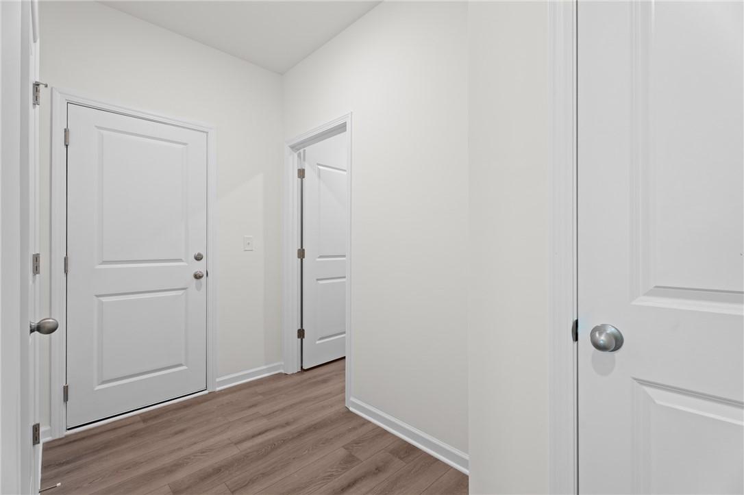 Bright entryway with wood-style flooring in The Stella D floor plan by Evermore Homes in Silver Oak, Cusseta, Alabama.