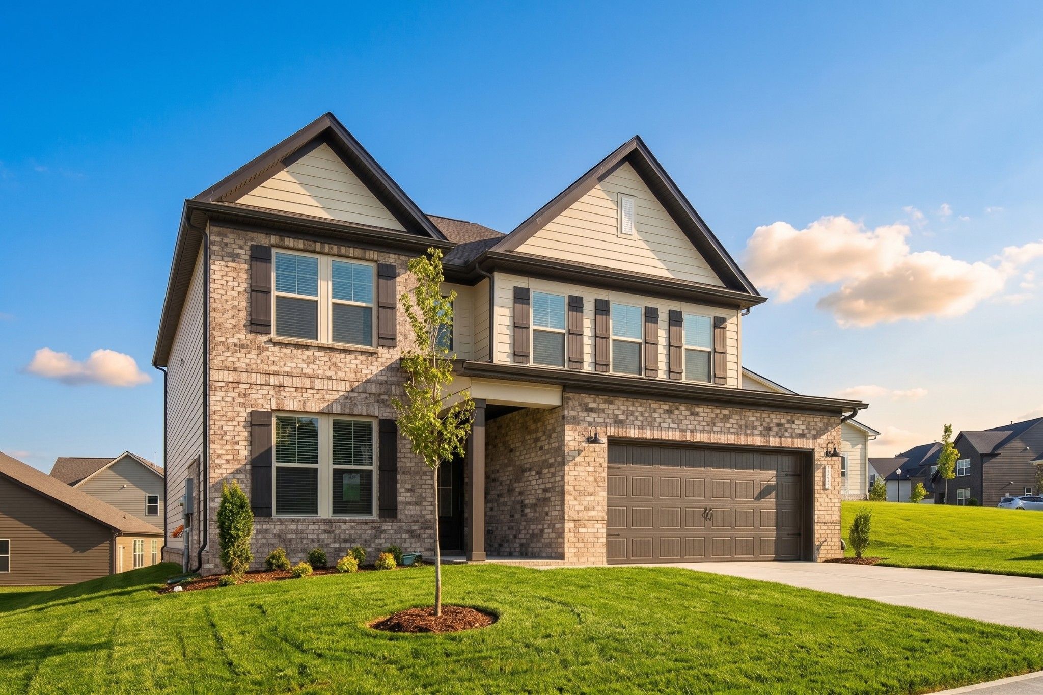 Two-story brick new construction home with 2-car garage by Davidson Homes in Woods Crossing, Gallatin, Tennessee