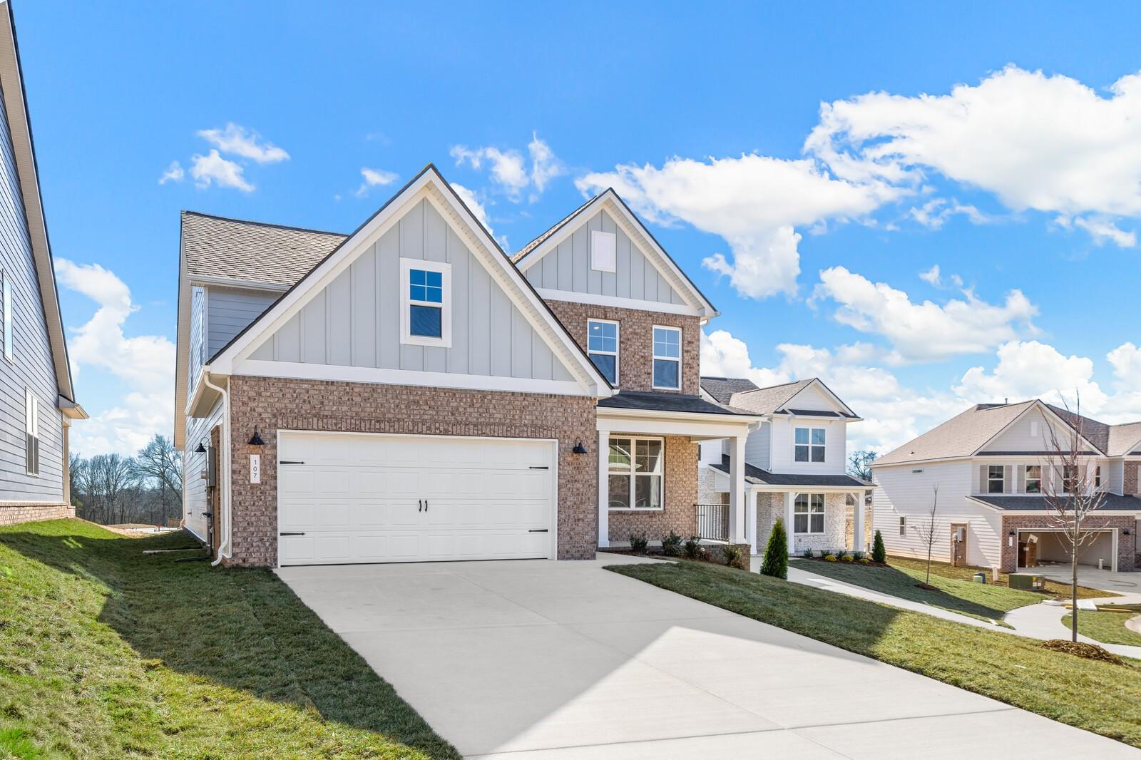 Modern two-story brick home with two-car garage and driveway in Woods Crossing, Gallatin, Tennessee by Davidson Homes The Ash A