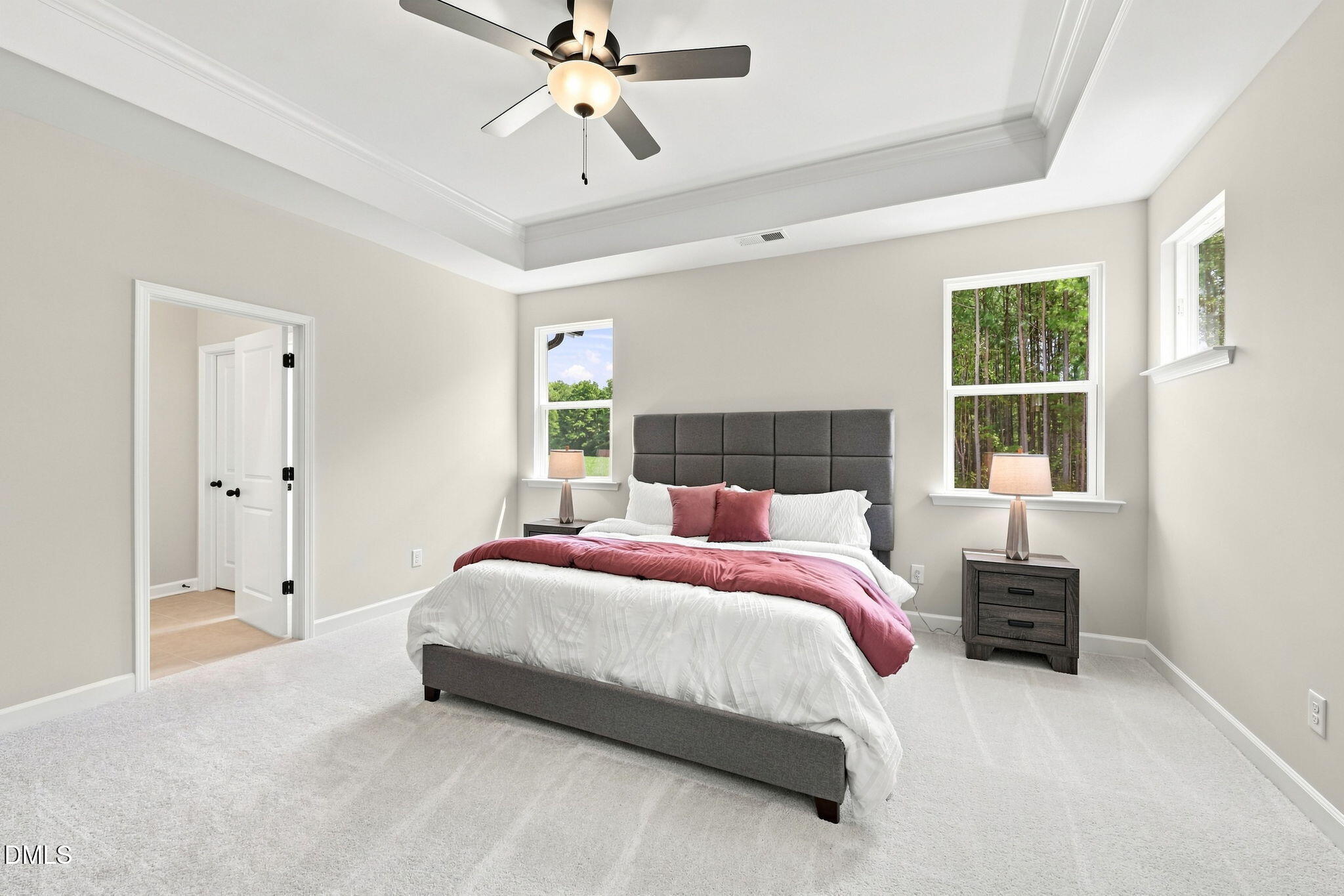 Spacious primary bedroom with tray ceiling in The Harris C floor plan at Forestville Yard, Knightdale, North Carolina.