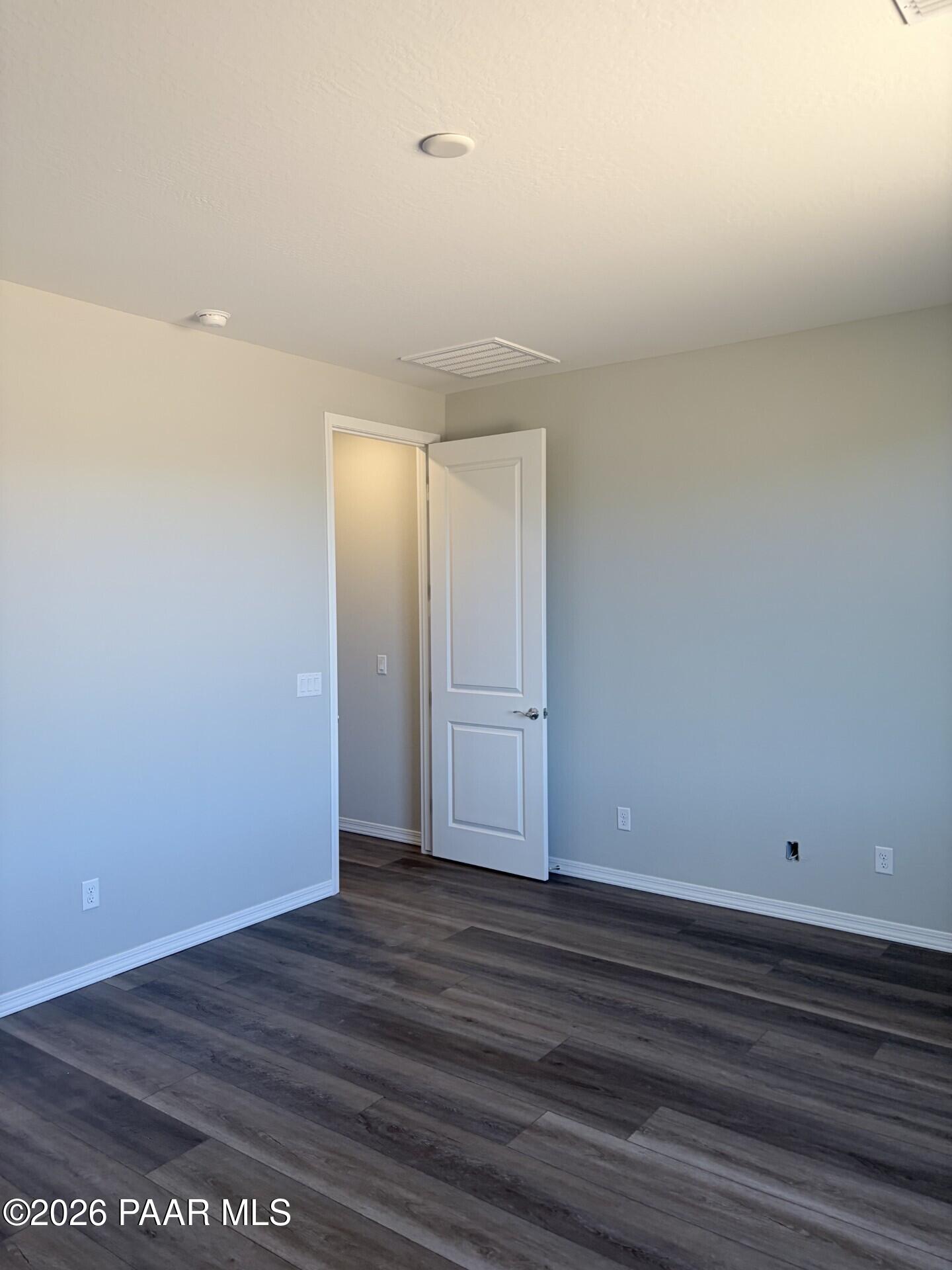 Spacious bedroom with luxury vinyl plank flooring in The Frontier A floor plan at North Ridge, Prescott Valley, Arizona.