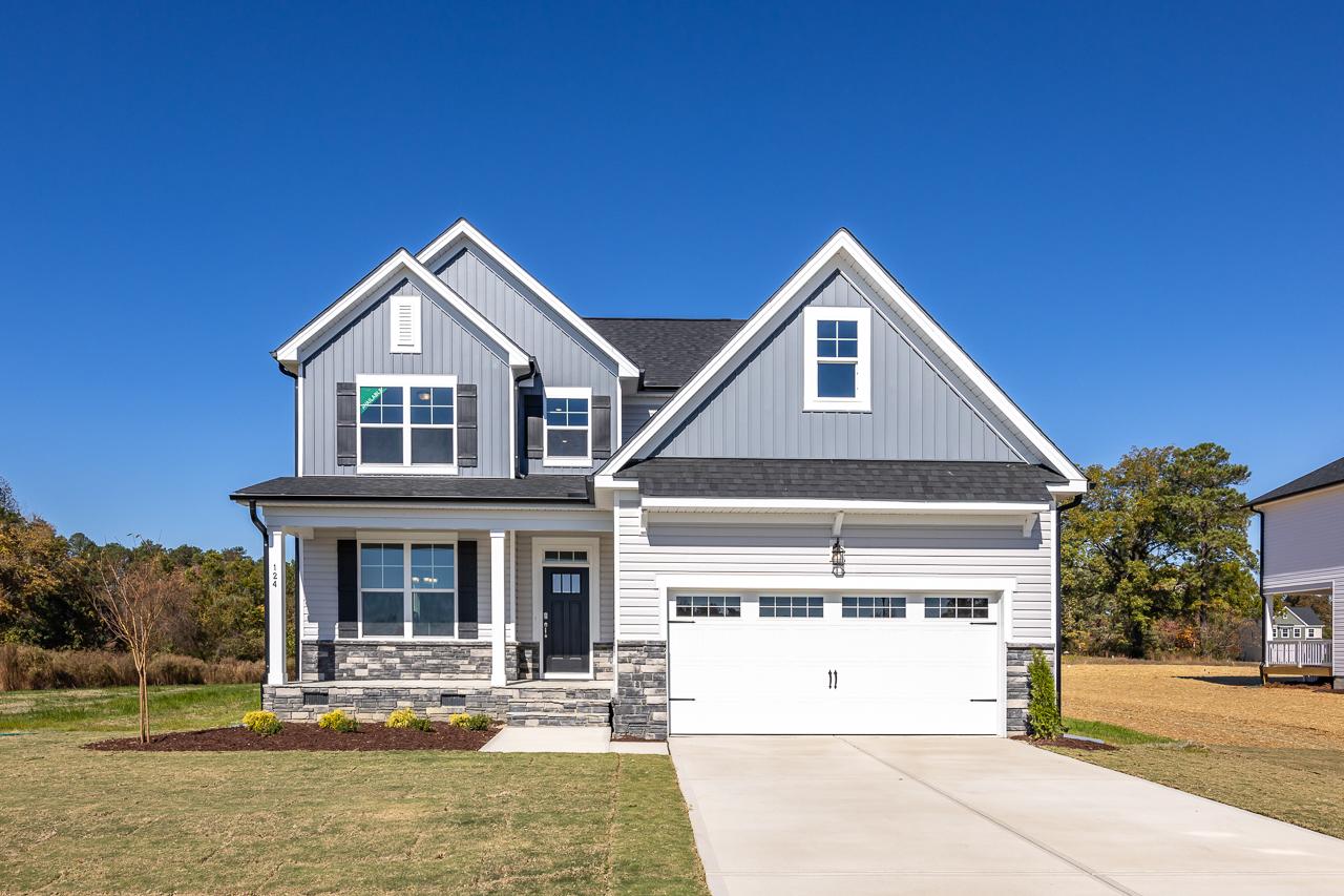 Gray two-story craftsman home exterior at Wellers Knoll in Lillington NC with covered porch, stone accents, and garage