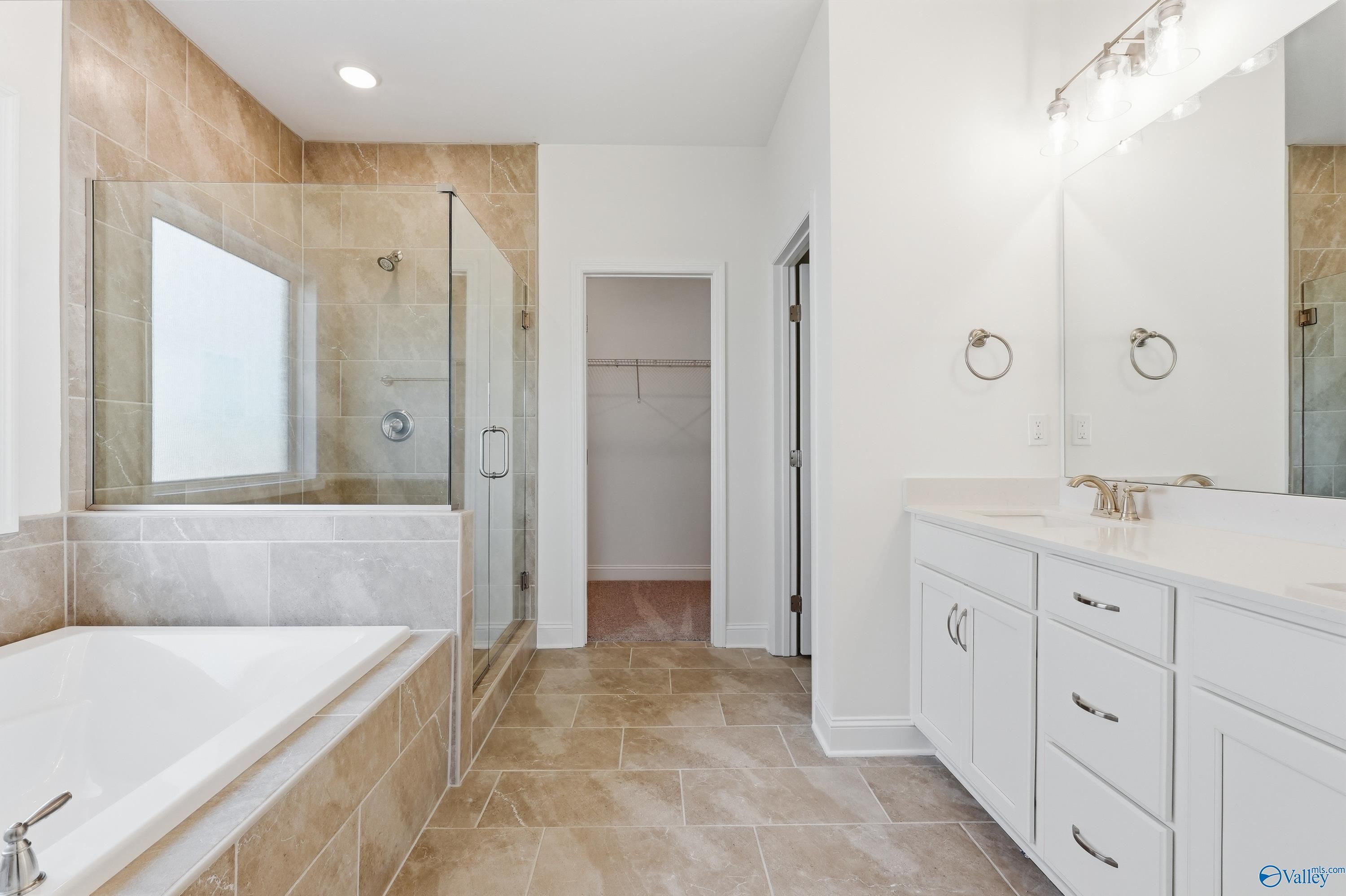 Modern master bathroom with glass shower, soaking tub, double vanity in Davidson Homes The Montgomery C, Harvest, Alabama