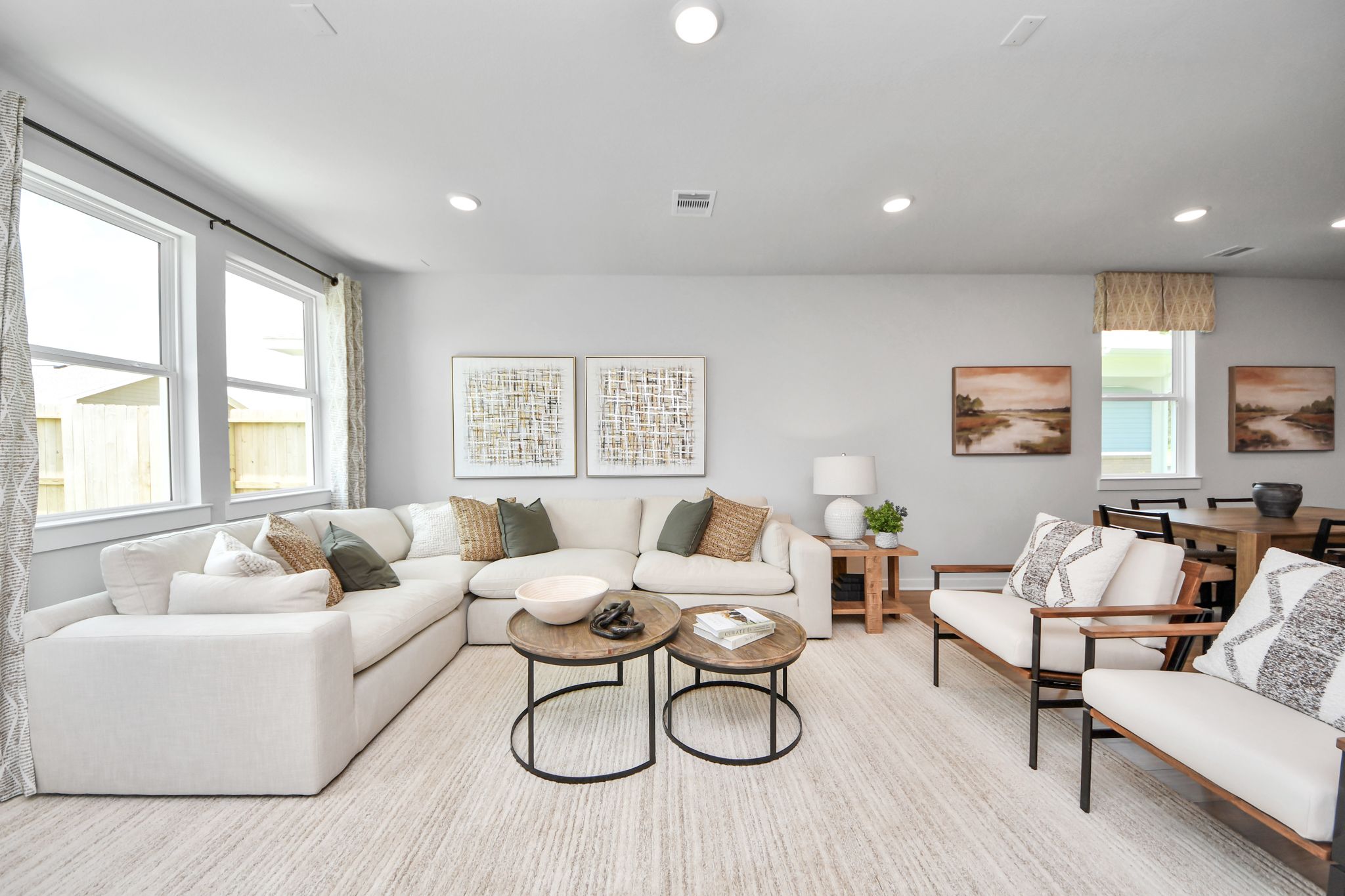 Spacious open-concept living room at Robins Landing in Houston with sectional seating and modern decor by Davidson Homes.