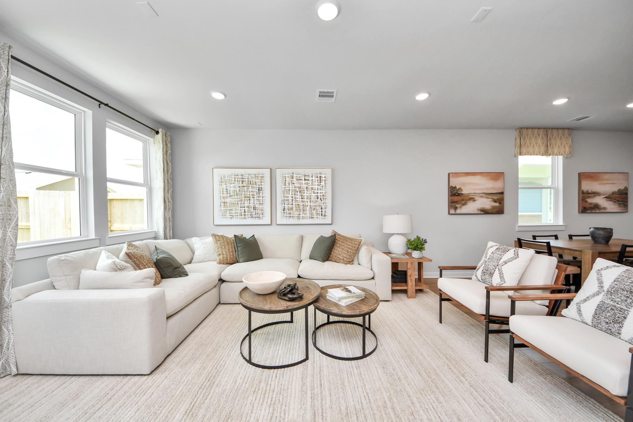 Spacious open-concept living room at Robins Landing in Houston with sectional seating and modern decor by Davidson Homes.