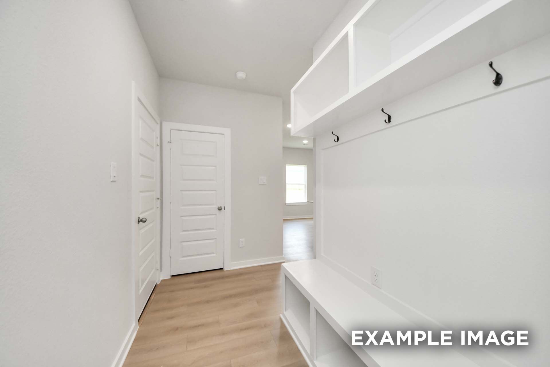 Mudroom with built-in bench, cubbies, and coat hooks in The Blanco, a Davidson Homes new construction plan in Beasley, Texas