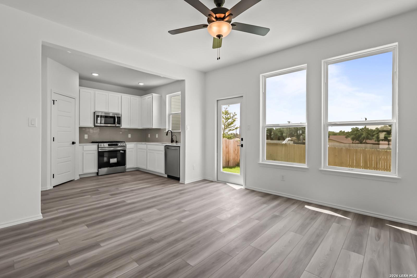 Modern kitchen with white cabinets and stainless appliances in The Florence B floor plan at Meadows at Oak Creek, San Antonio.
