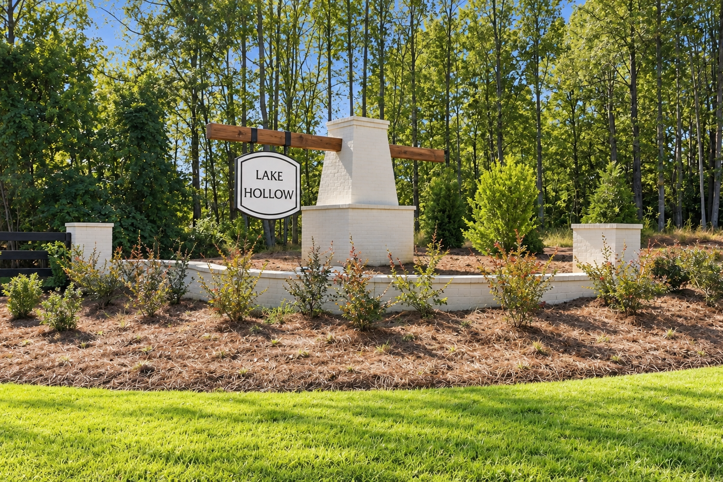 Lake Hollow community entrance sign in Gainesville, Georgia by Davidson Homes with white brick monument and landscaped greenery