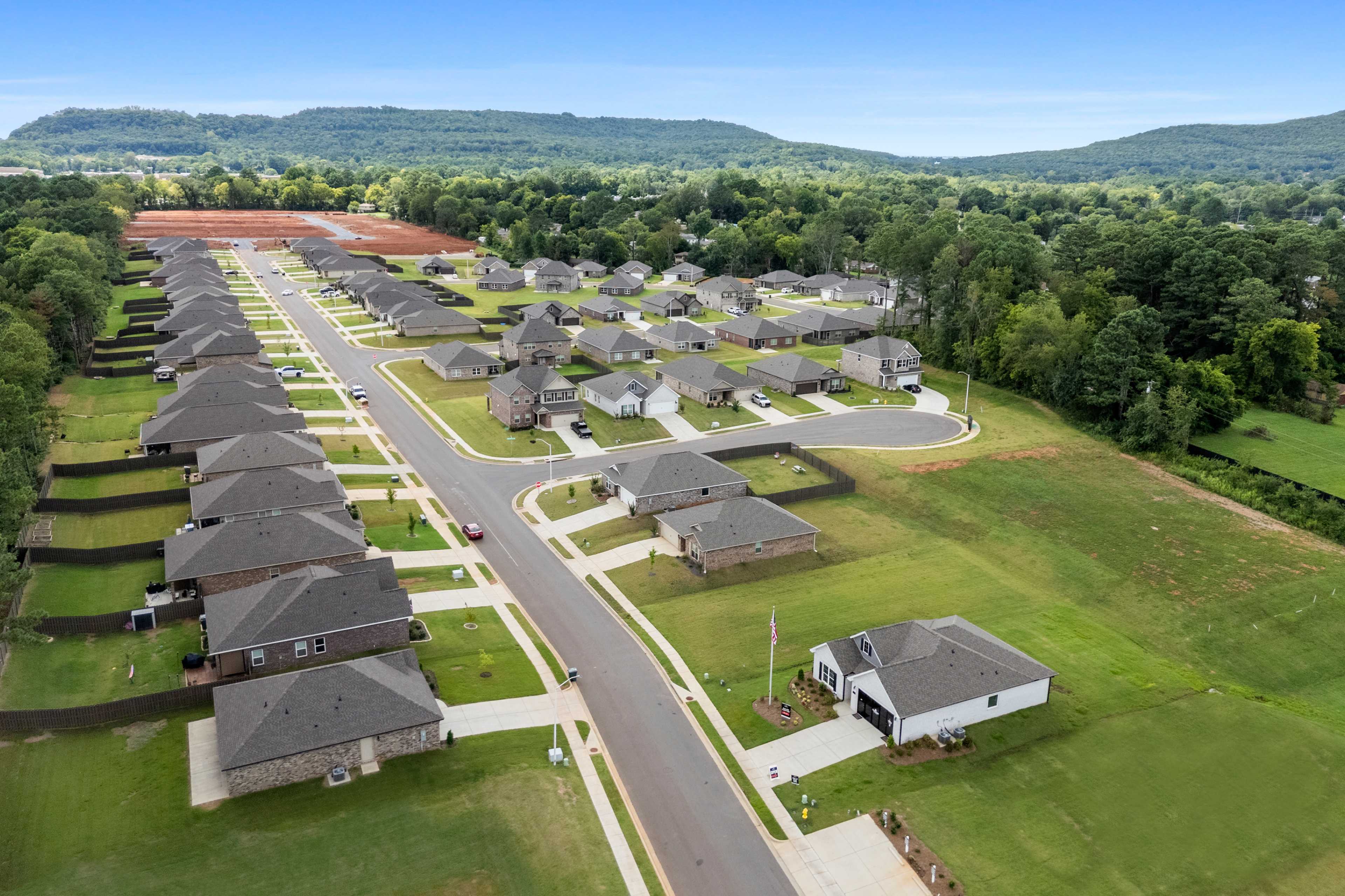 Aerial view of new homes in Blue Spring, Huntsville Alabama by Davidson Homes with tree-lined streets and scenic hills