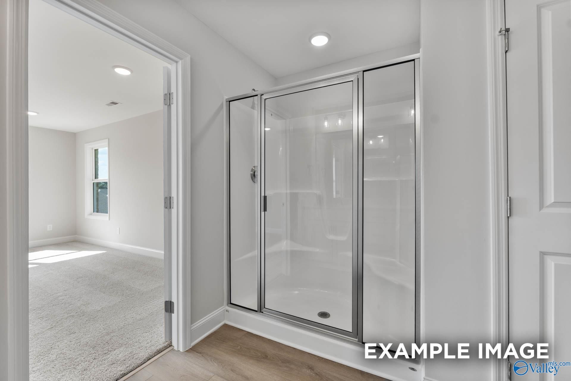 Modern frameless glass shower in master bath of Davidson Homes Chelsea D, New Market, Alabama