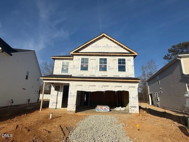 Two-story Preston A home under construction with 2-car garage and white sheathing in Gregory Village, Lillington, North Carolina