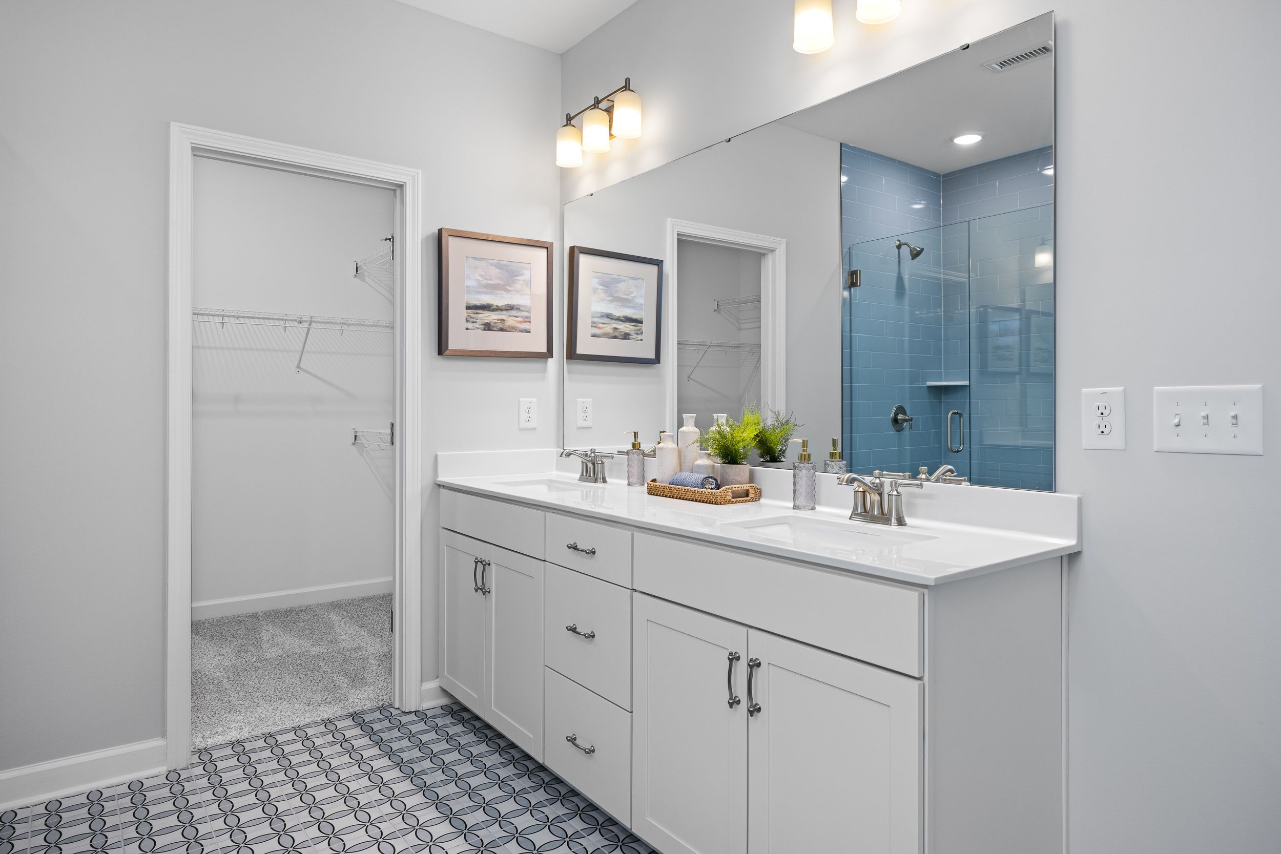 Spacious master bathroom in The Magnolia B with double vanity, frameless glass shower, and walk-in closet, Davidson Homes design