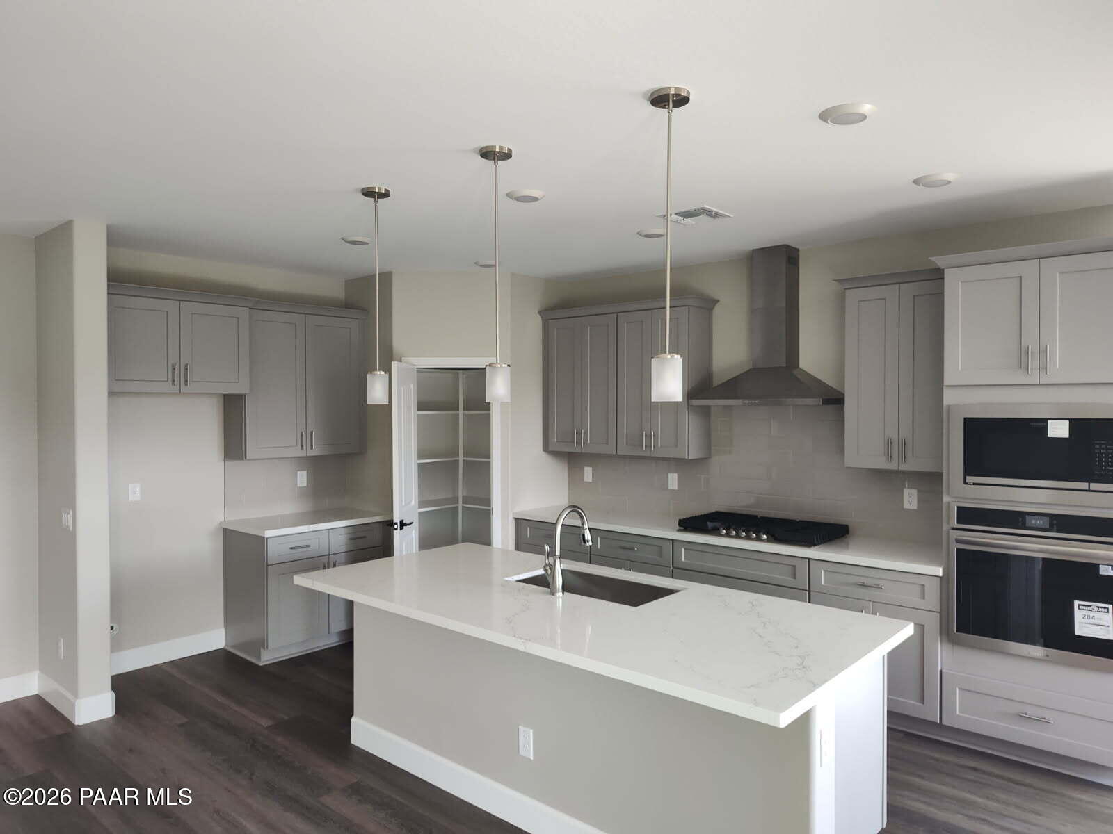 Modern kitchen featuring gray cabinets, quartz island sink, stainless steel range in Davidson Homes The Harmony C, Prescott Valley, AZ