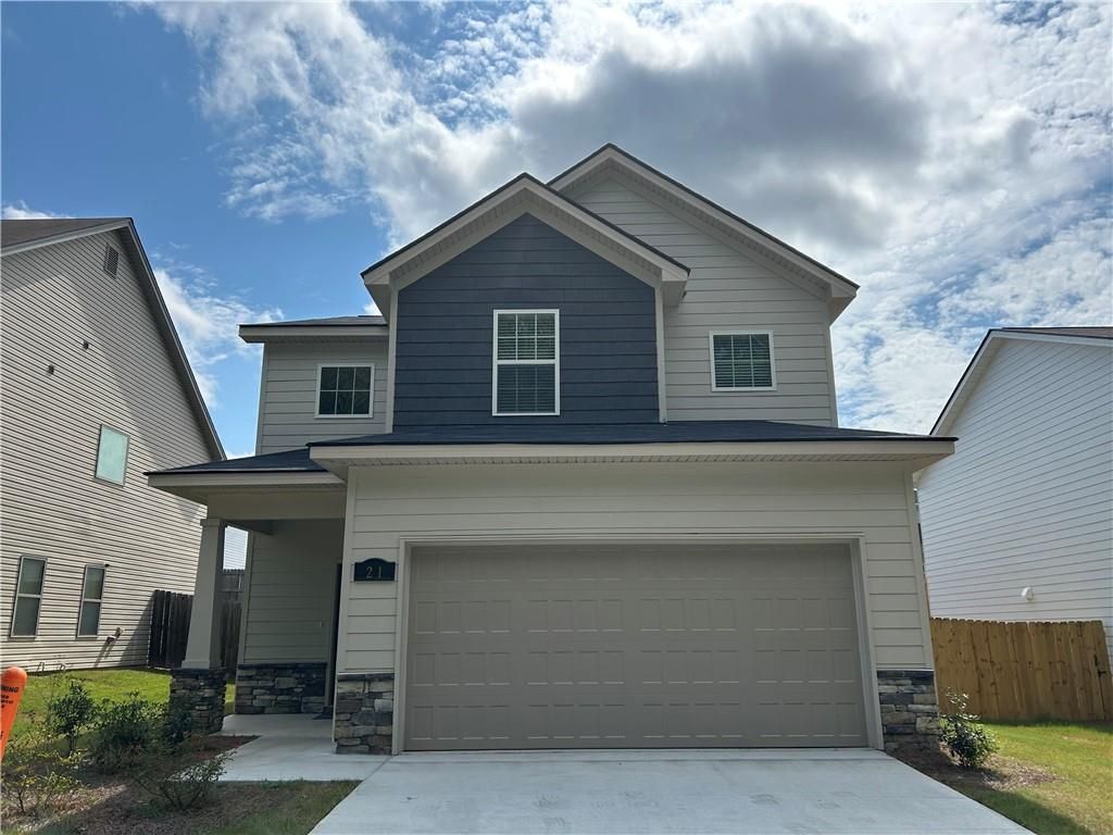 Modern 2-story Bartlett home by Davidson Homes in Summer Vineyard, Phenix City, AL: navy blue siding, 2-car garage, front porch