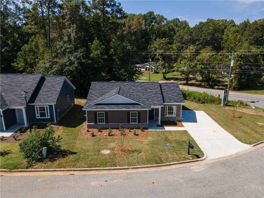 Modern 1-story gray home with driveway, shrubs, and trees in Summer Vineyard, Phenix City, Alabama by Davidson Homes
