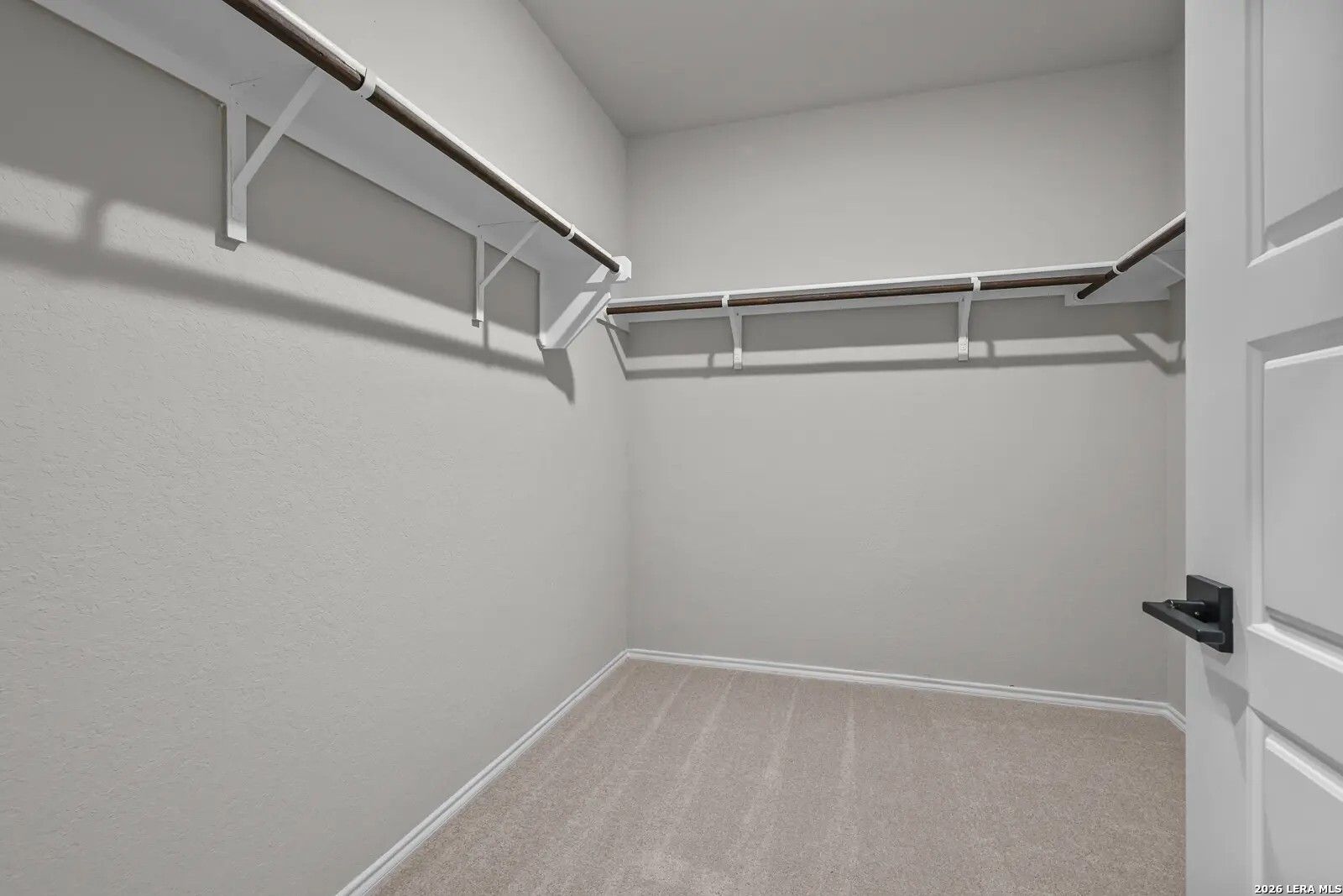 Walk-in closet with built-in shelving in The Glenwood E floor plan by Davidson Homes in Comanche Ridge, San Antonio, Texas.