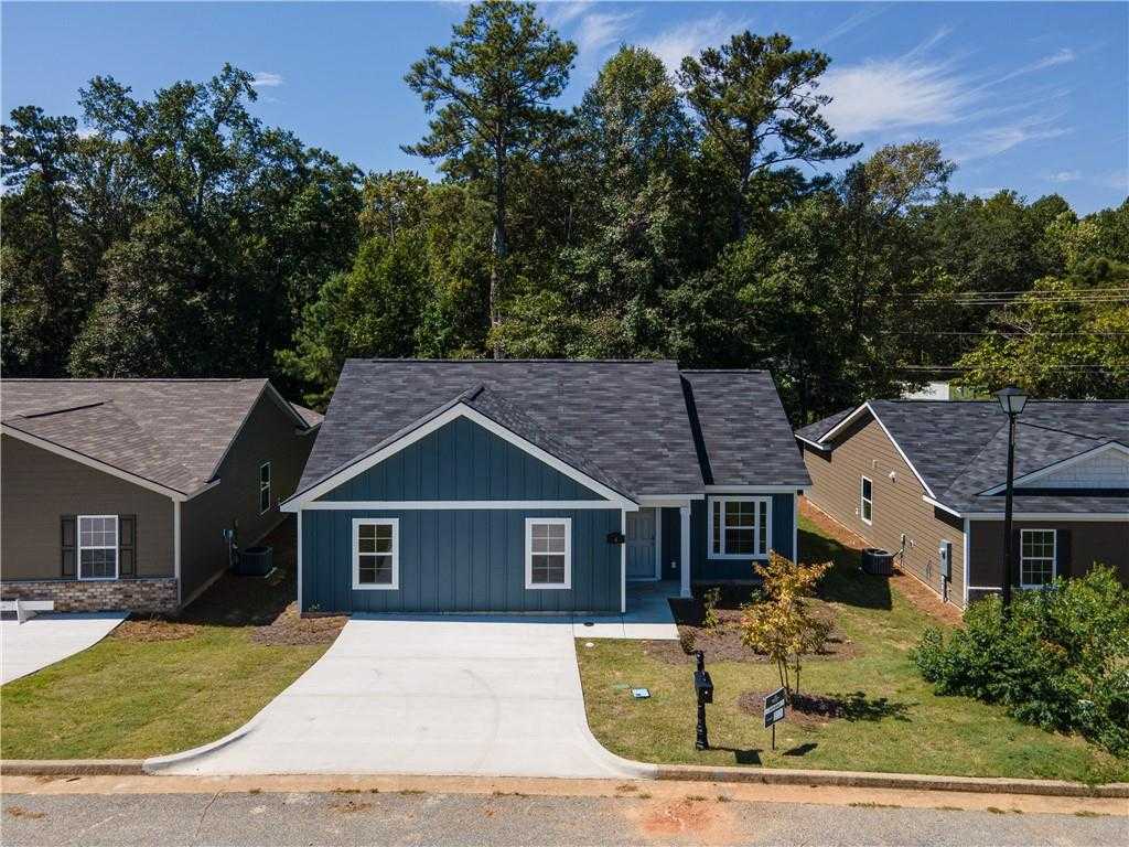 Modern blue single-story home with 1-car garage, driveway, and lush yard in Summer Vineyard, Phenix City, Alabama by Davidson Homes