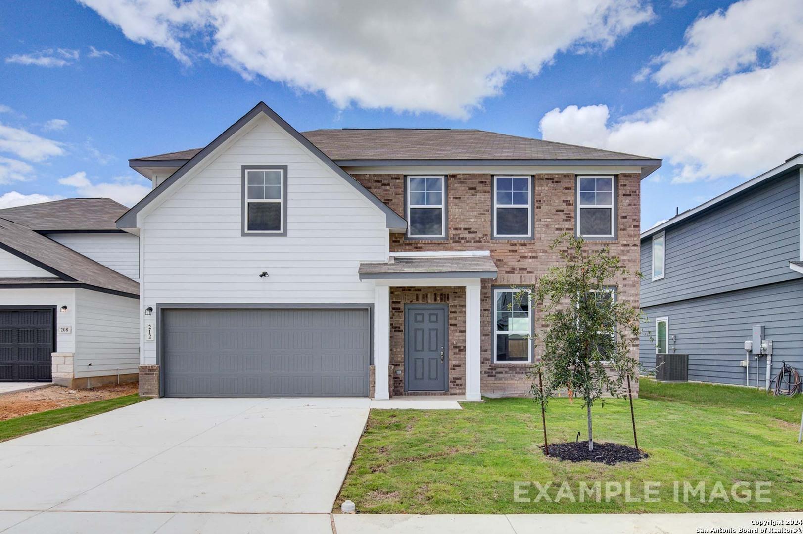 Modern two-story home with white siding, brick accents, 2-car garage and front porch in Bricewood, San Antonio, Texas - Davidson Homes The Murray J