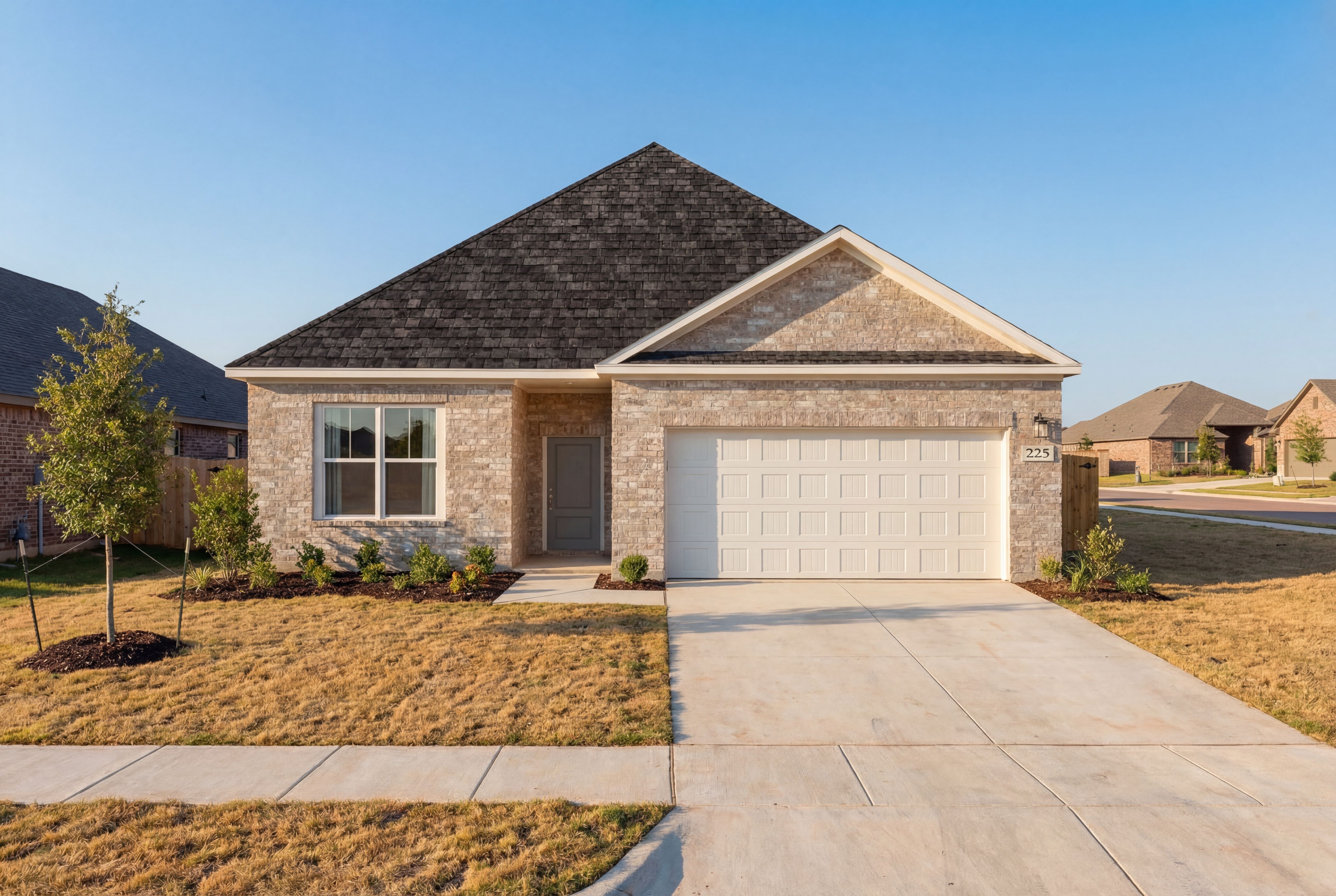 Front elevation of The Holly single-story home with brick facade, dark shingle roof, two-car garage, and landscaped yard in Josephine, Texas