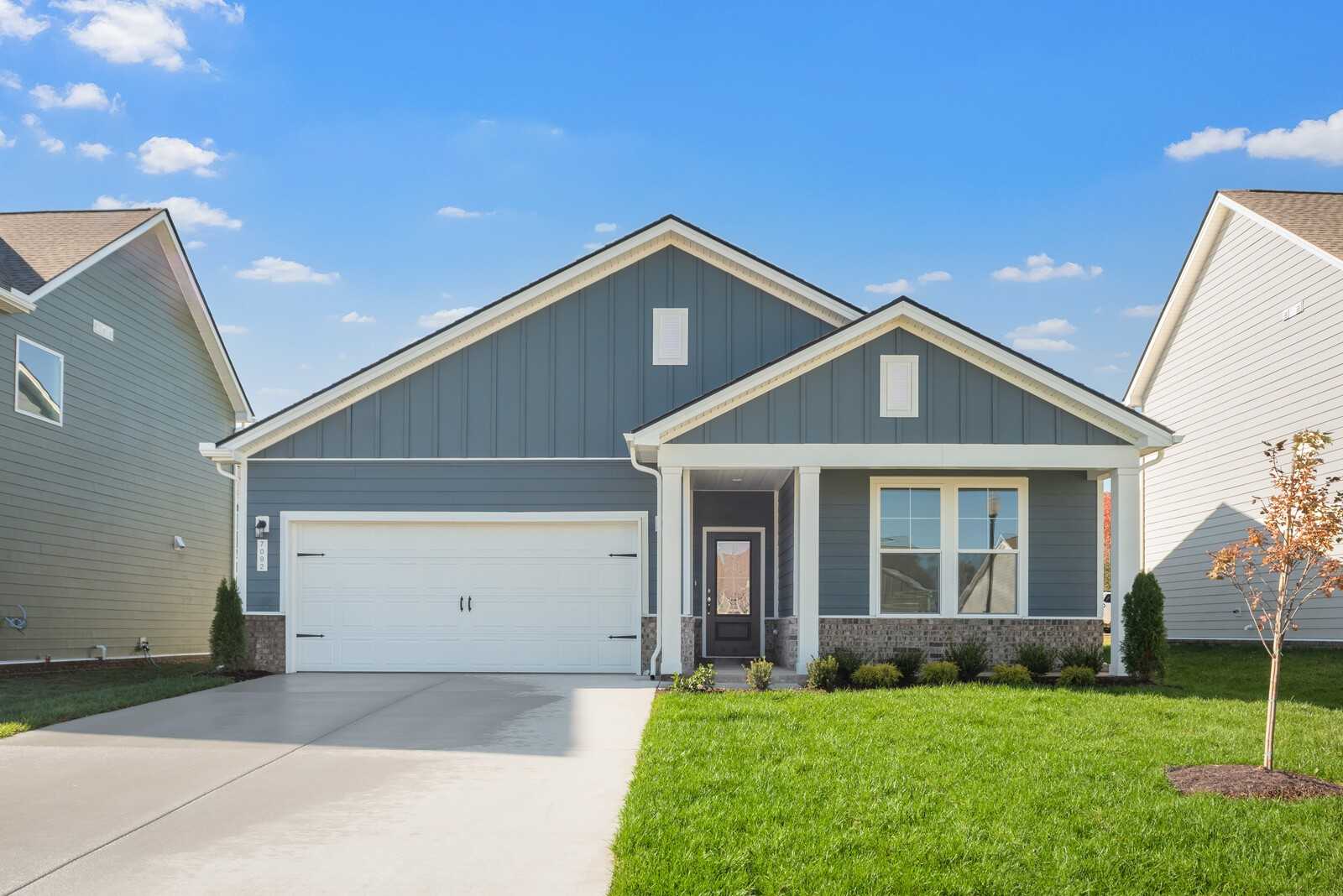Gray single-story Davidson Homes The Franklin B with 2-car garage, front porch, and green lawn in Sage Farms, White House, TN