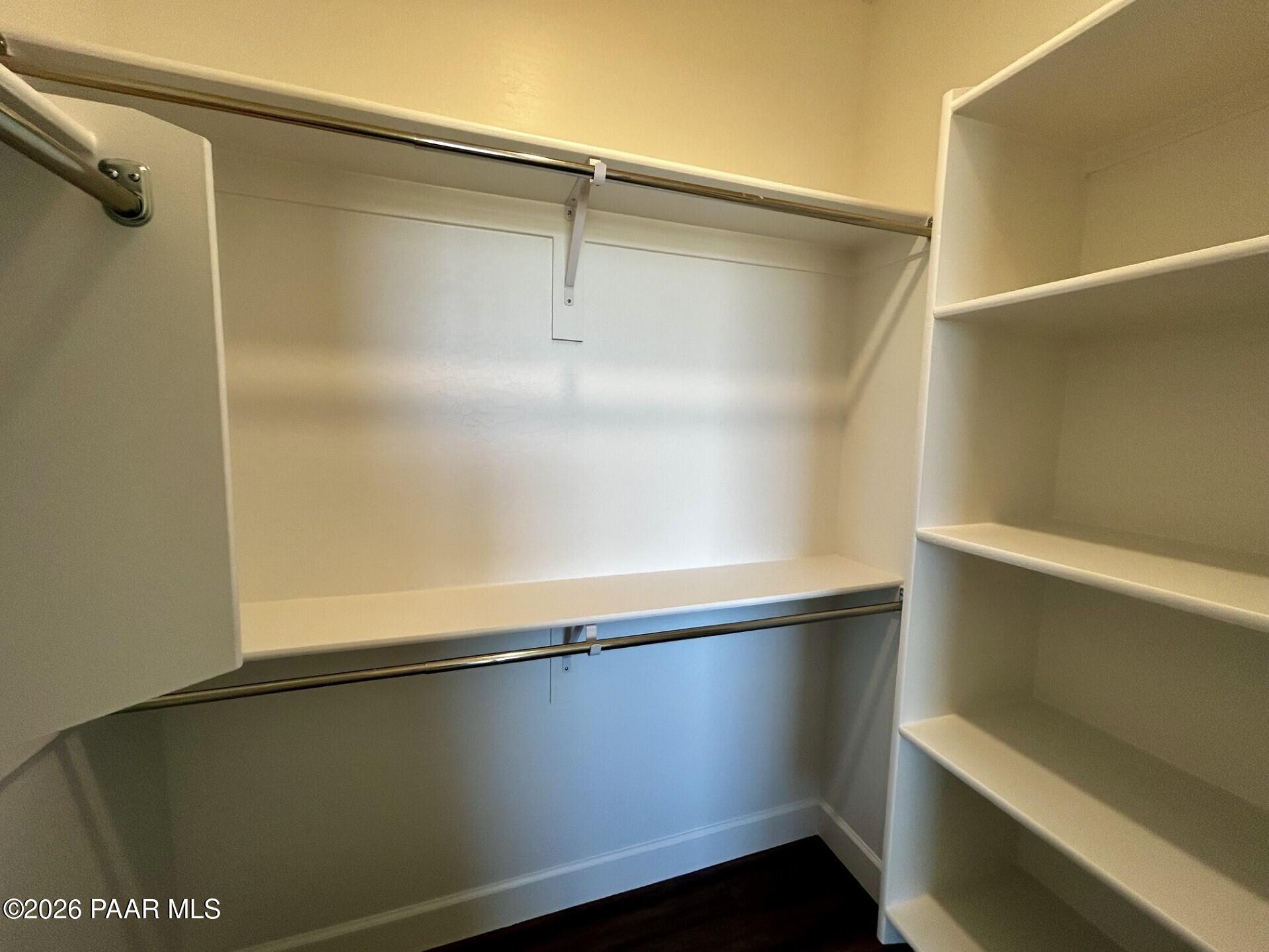 Walk-in closet with built-in shelving and dual hanging rods in The Harmony C floor plan at North Ridge, Prescott Valley.