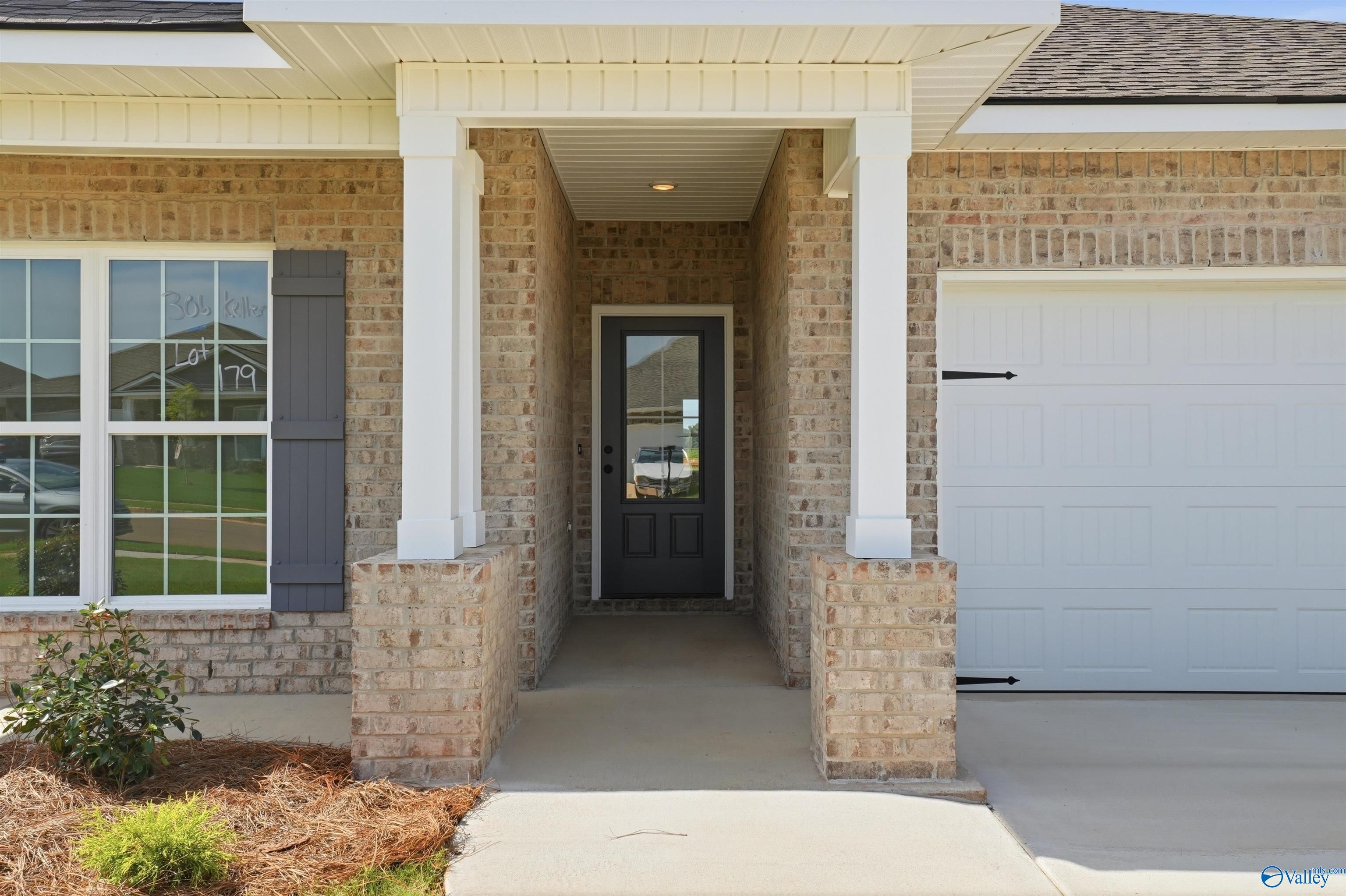 Brick exterior front porch and entryway of The Franklin B floor plan by Davidson Homes in Clearview, Hazel Green, Alabama.
