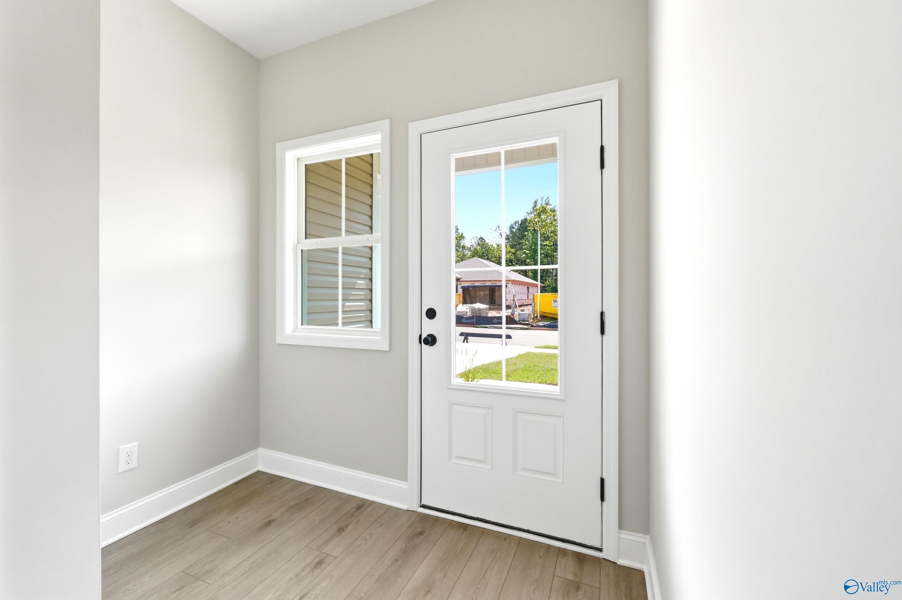 Light-filled entryway with wood-look flooring in The Russell A floor plan by Davidson Homes in Spragins Cove, Huntsville.