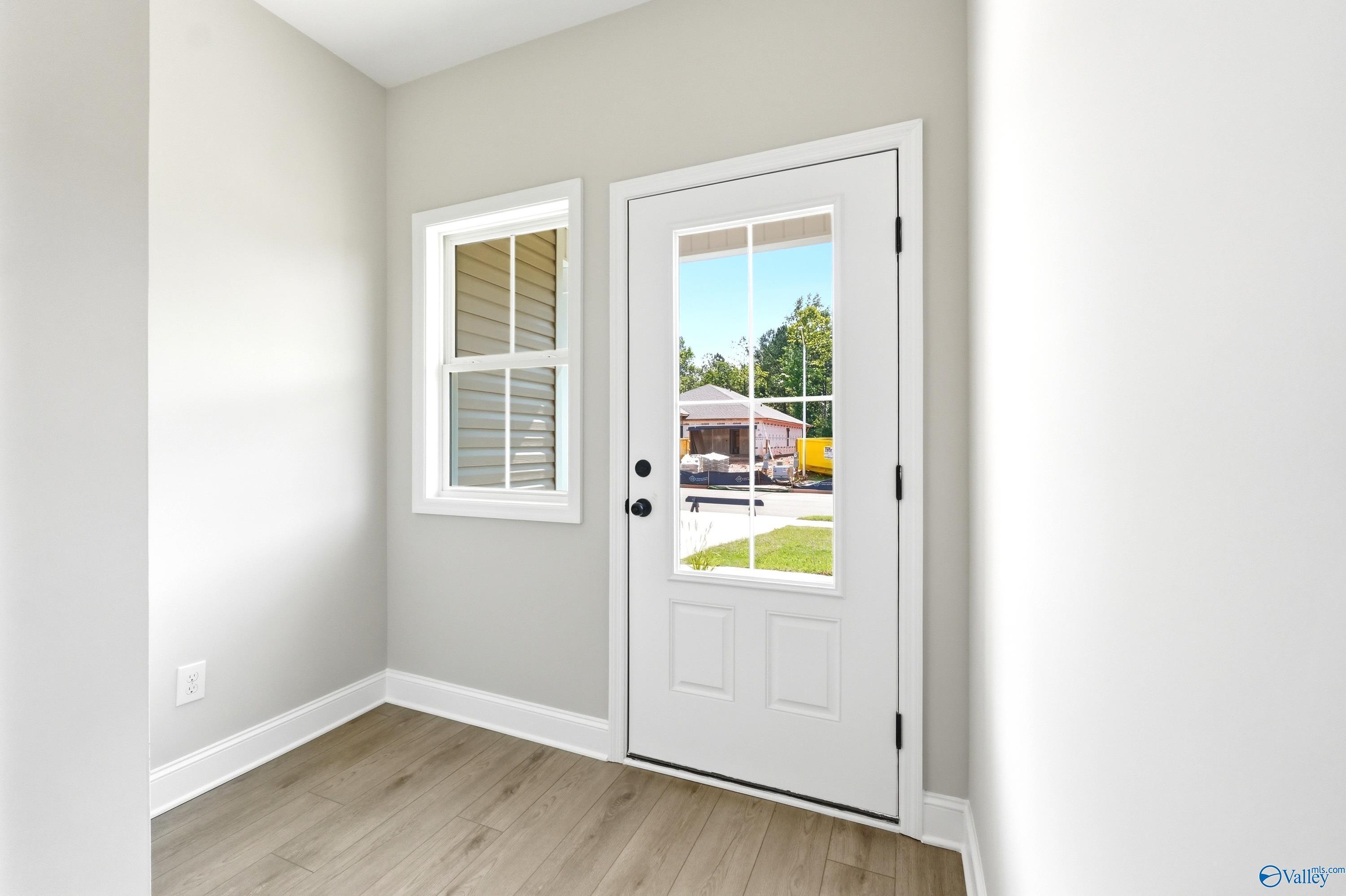Light-filled entryway with wood-look flooring in The Russell A floor plan by Davidson Homes in Spragins Cove, Huntsville.