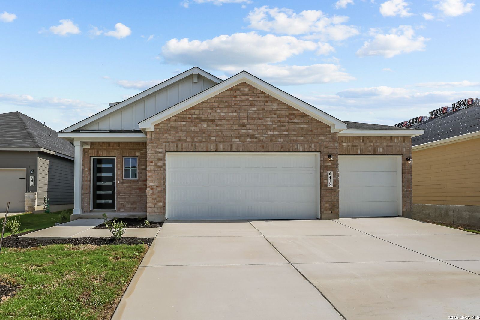 Brick exterior with 3-car garage and covered porch at The Pinecrest F new home in Morgan Meadows, San Antonio, Texas by Davidson Homes