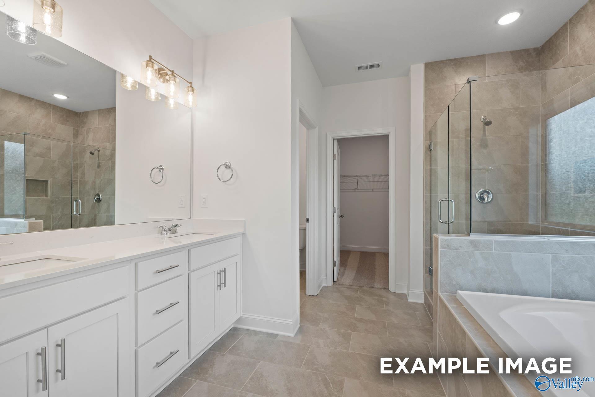 Luxurious master bathroom with double vanity, glass shower, freestanding tub in Davidson Homes The Rockford B, Athens, Alabama