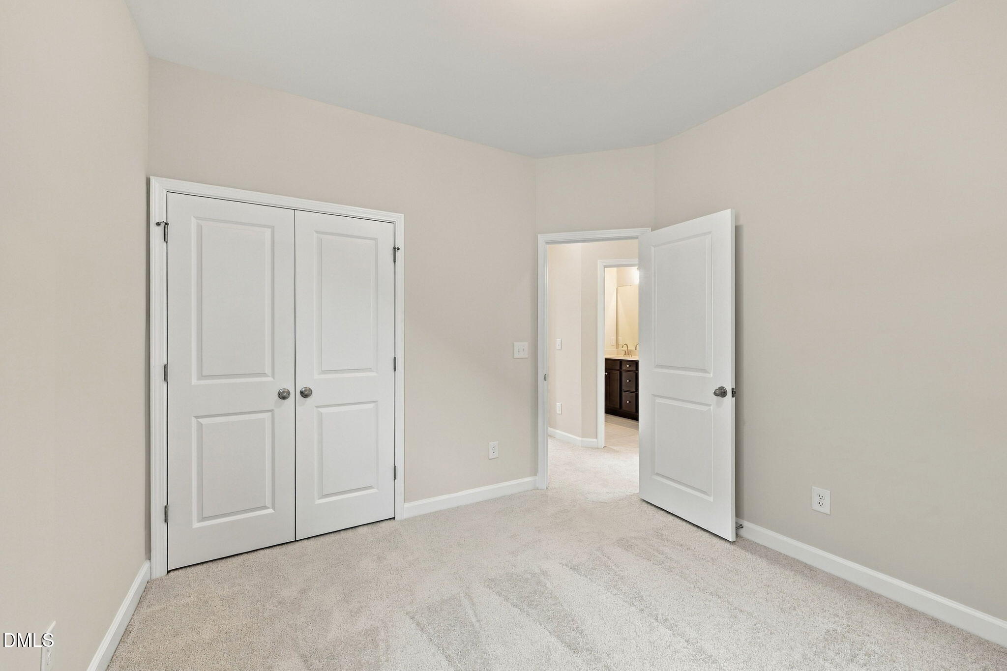 Bright bedroom with dual-door closet and plush carpet in Davidson Homes The Alexander B, Knightdale, North Carolina