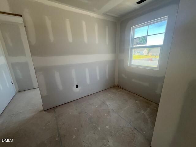 Unfinished bedroom with drywall and window view in Davidson Homes' The Ash C, 4-bedroom new construction home in Lillington, NC