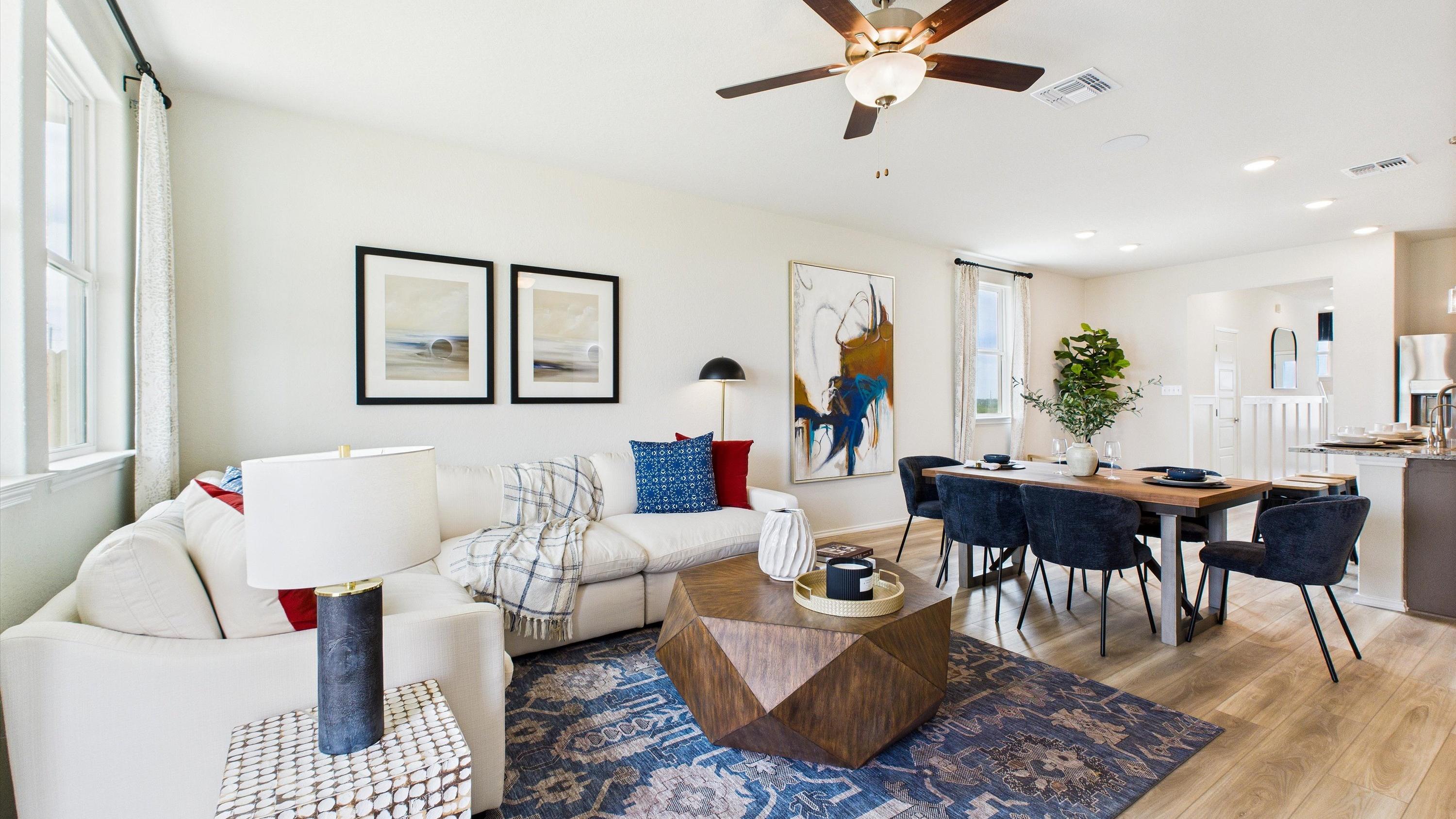 Modern kitchen in Agave San Antonio home by Davidson Homes featuring dark cabinets, granite island, stainless appliances and bar seating