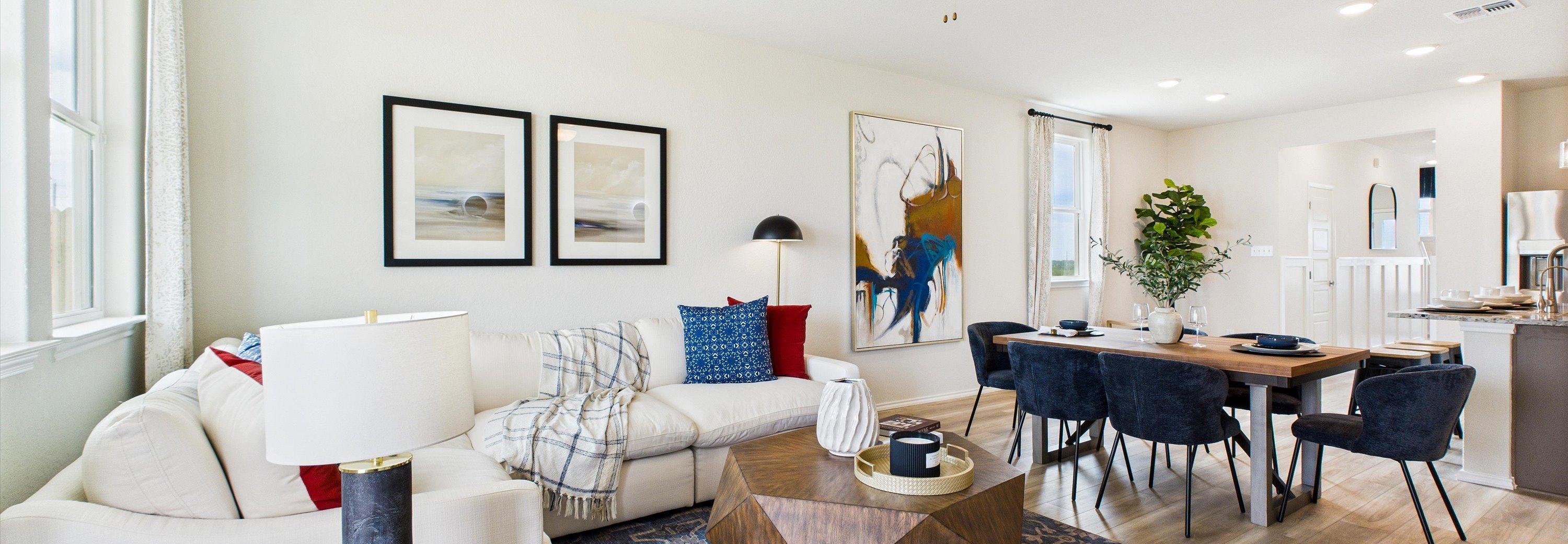 Modern kitchen in Agave San Antonio home by Davidson Homes featuring dark cabinets, granite island, stainless appliances and bar seating