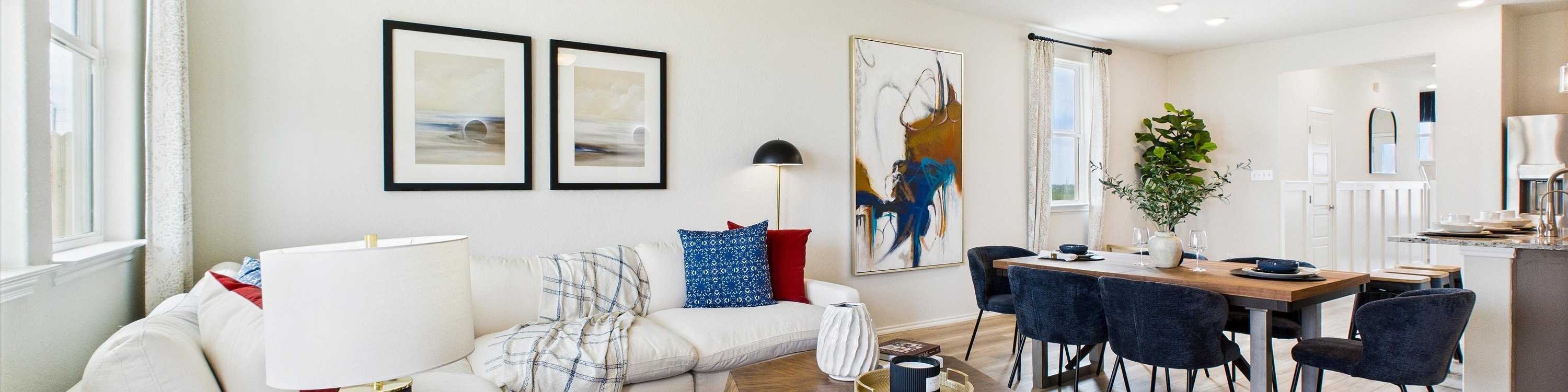 Modern kitchen in Agave San Antonio home by Davidson Homes featuring dark cabinets, granite island, stainless appliances and bar seating