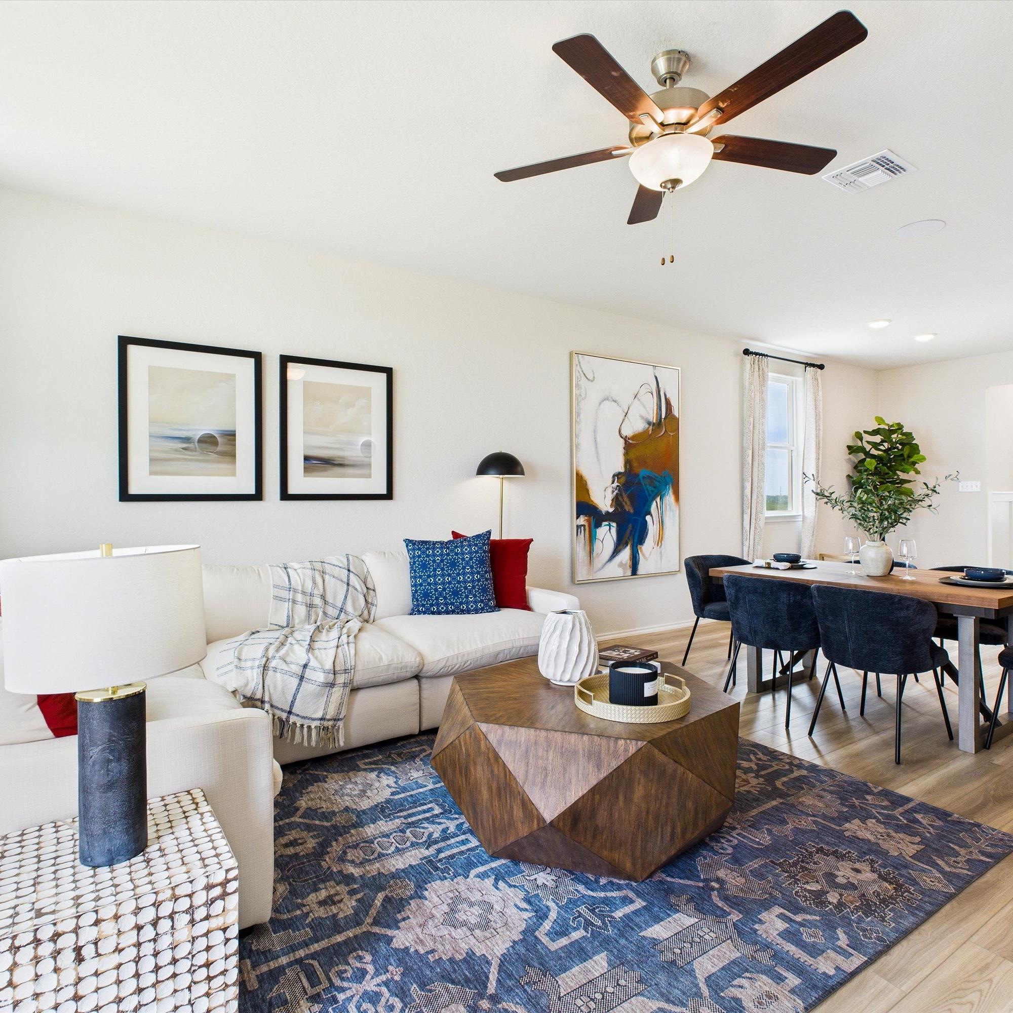 Modern kitchen in Agave San Antonio home by Davidson Homes featuring dark cabinets, granite island, stainless appliances and bar seating