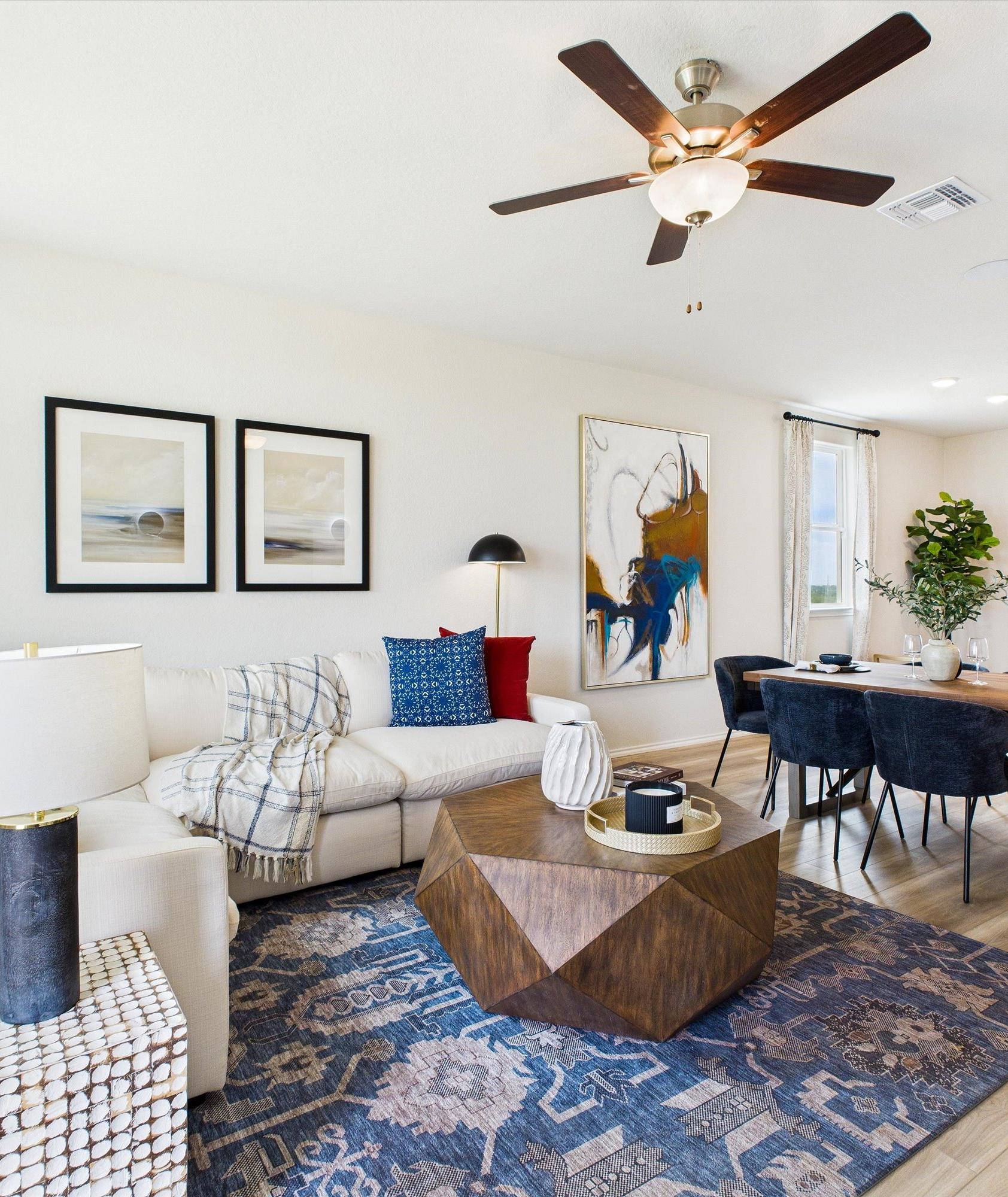 Modern kitchen in Agave San Antonio home by Davidson Homes featuring dark cabinets, granite island, stainless appliances and bar seating