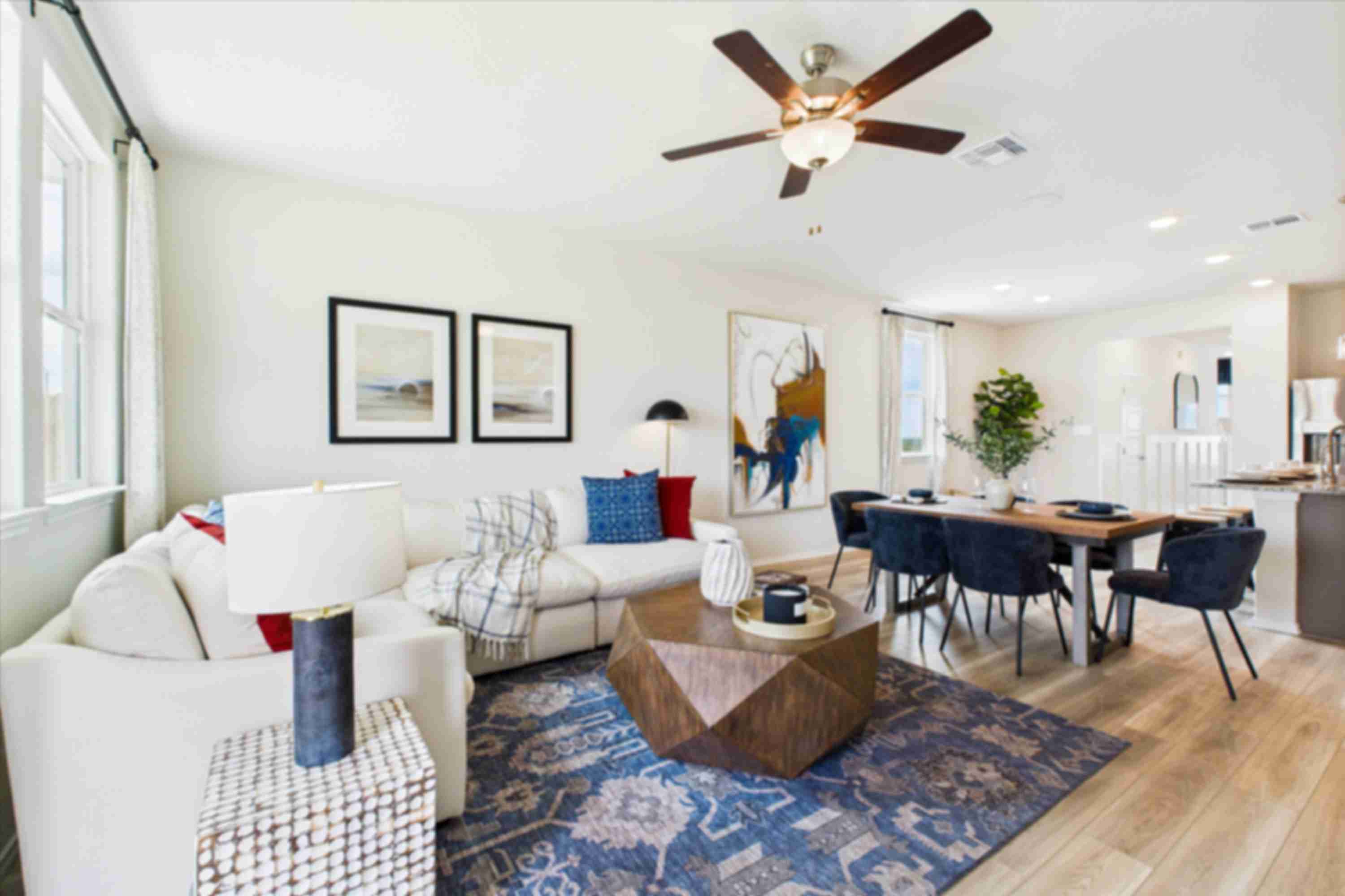 Modern kitchen in Agave San Antonio home by Davidson Homes featuring dark cabinets, granite island, stainless appliances and bar seating