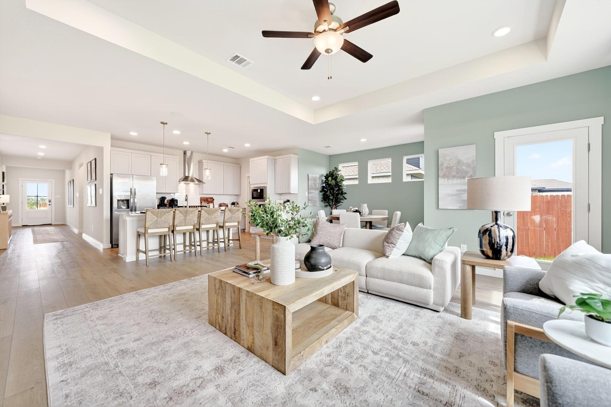 Open-concept living room and kitchen in The Laurel M floor plan at Parks at Foster Crossing, Anna, Texas.