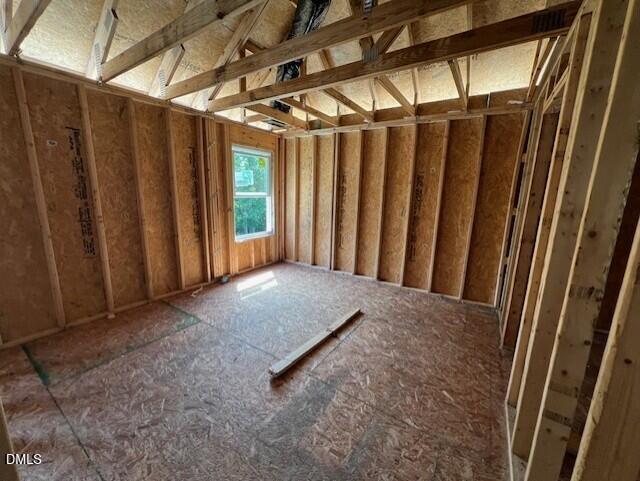 Unfinished bedroom framing with vaulted ceiling under construction in a Davidson Homes Willow D model in Lillington, NC.