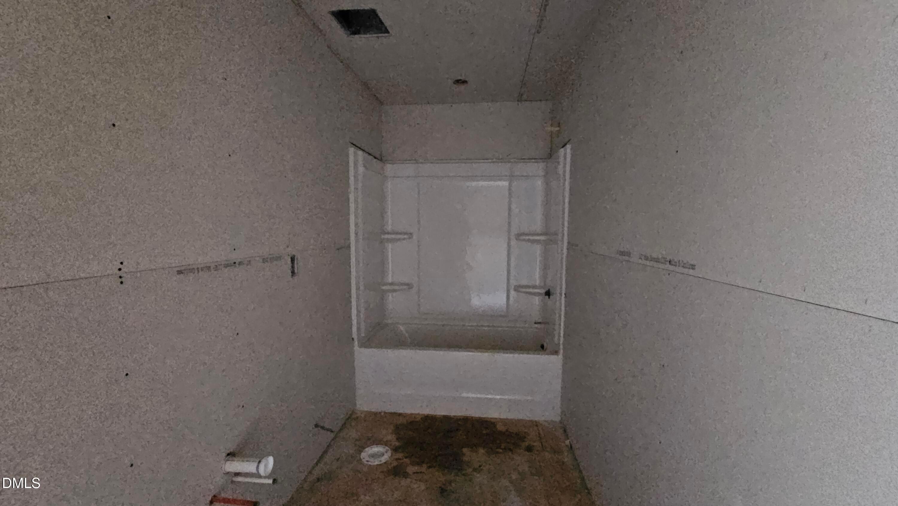 Unfinished bathroom with white tub shower surround in The Graham floor plan at Springvale, Fuquay-Varina, North Carolina.