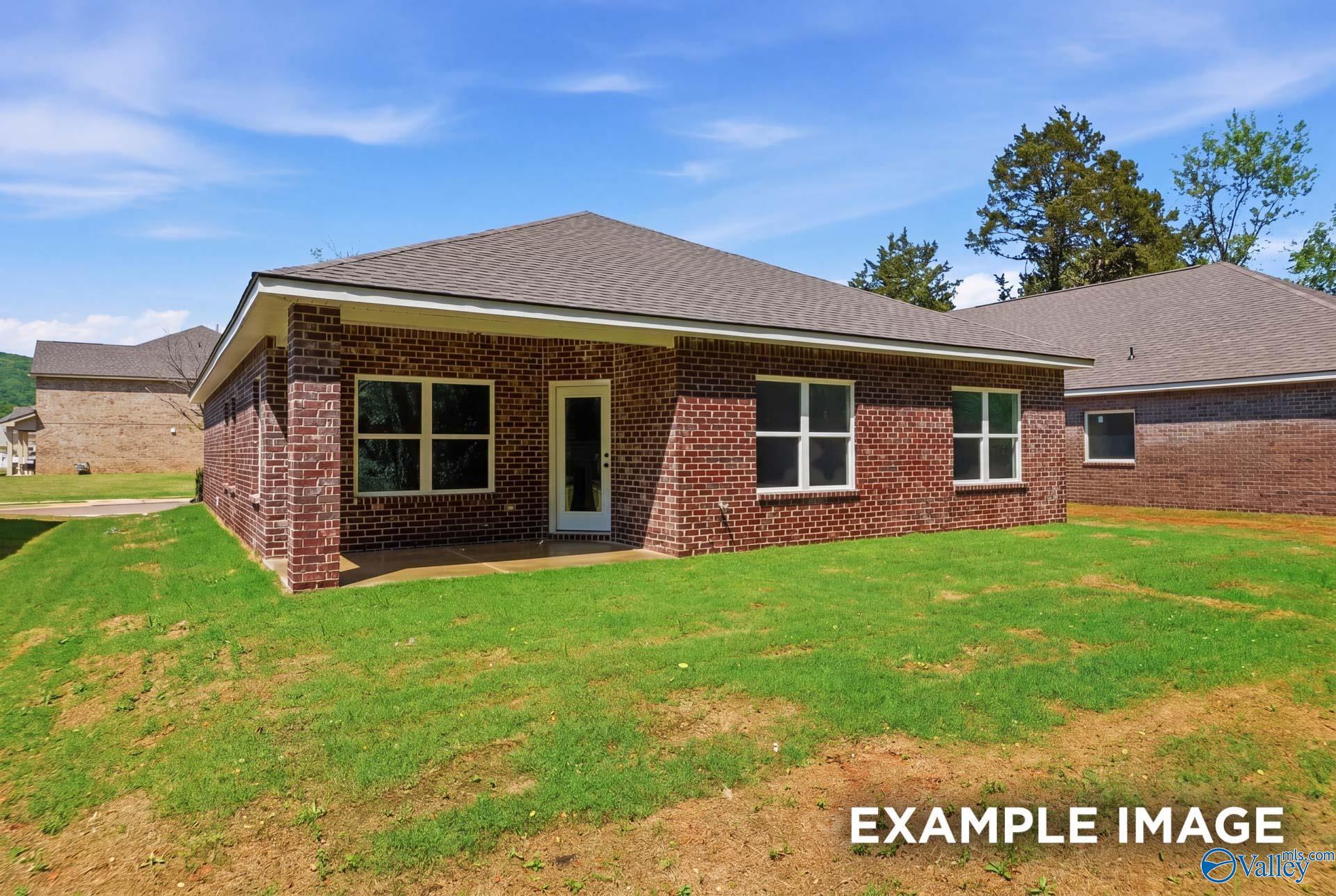 Back exterior view of Franklin C floor plan by Davidson Homes featuring brick siding in The Highlands, Arab, Alabama.