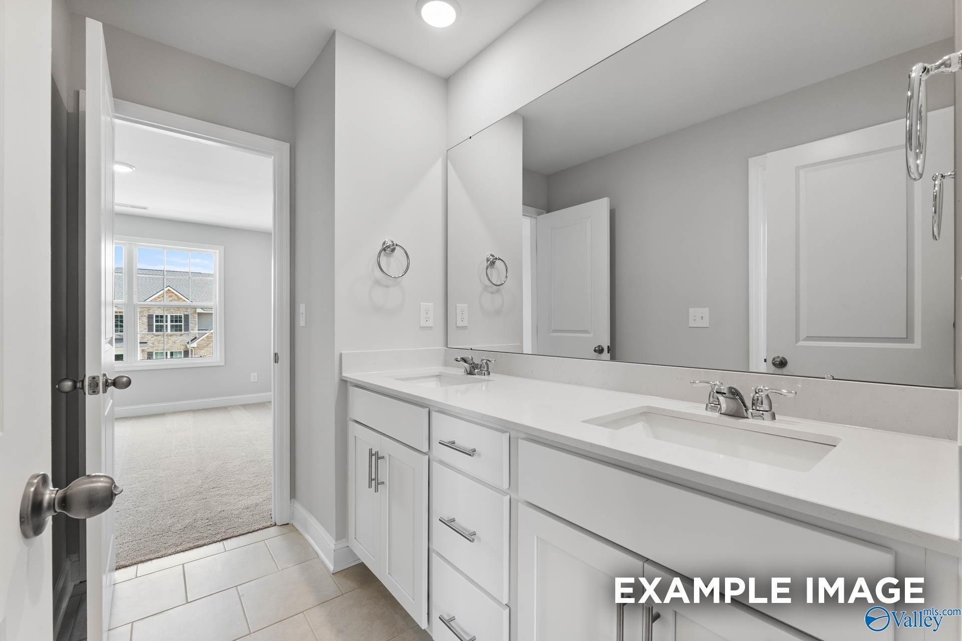 Modern double vanity bathroom with white cabinets in Davidson Homes The Madison D floor plan, Evergreen Mill, Madison, AL.