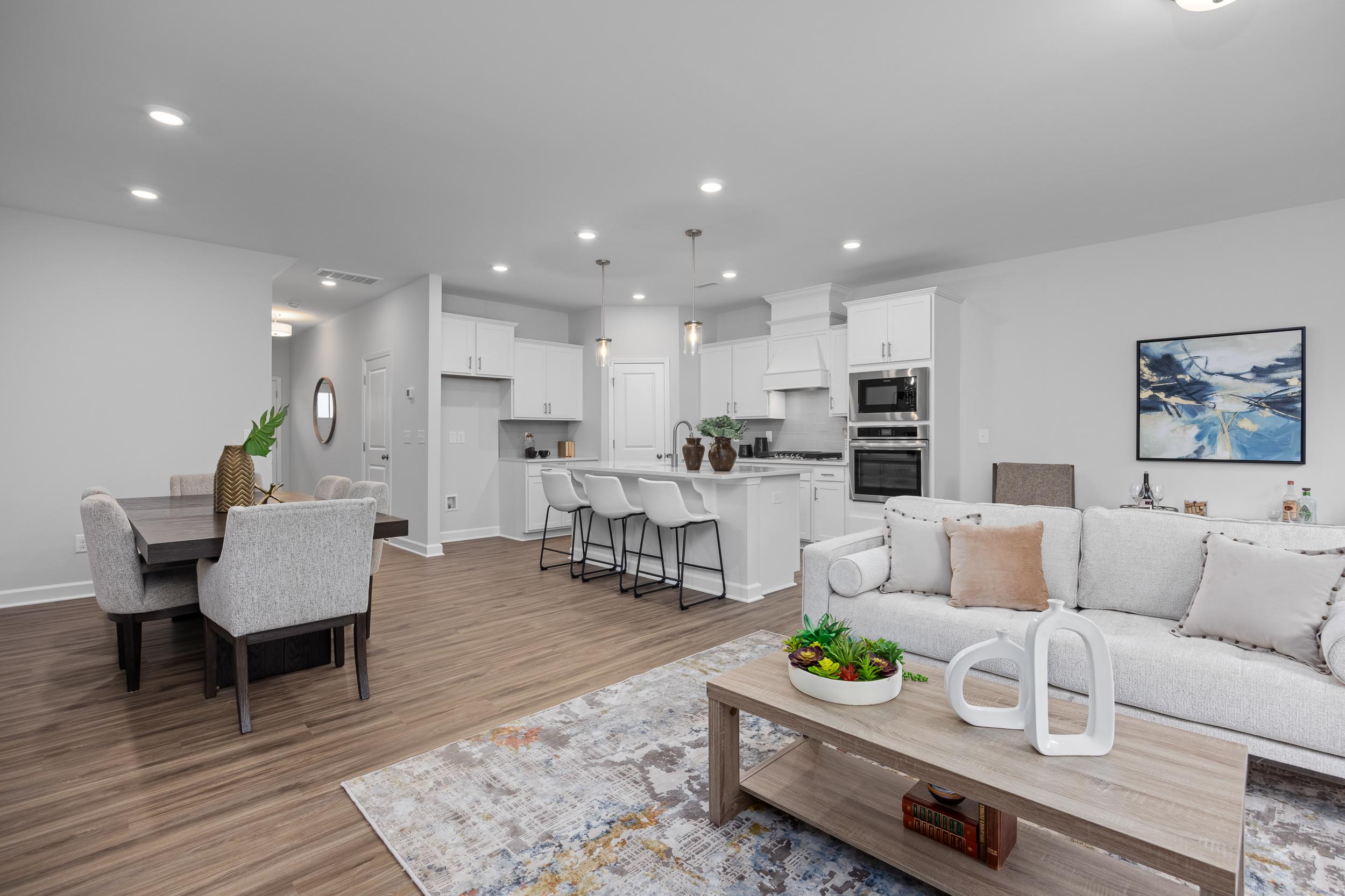 Open-concept living and dining area in The Warren floor plan featuring a modern kitchen with a large island.