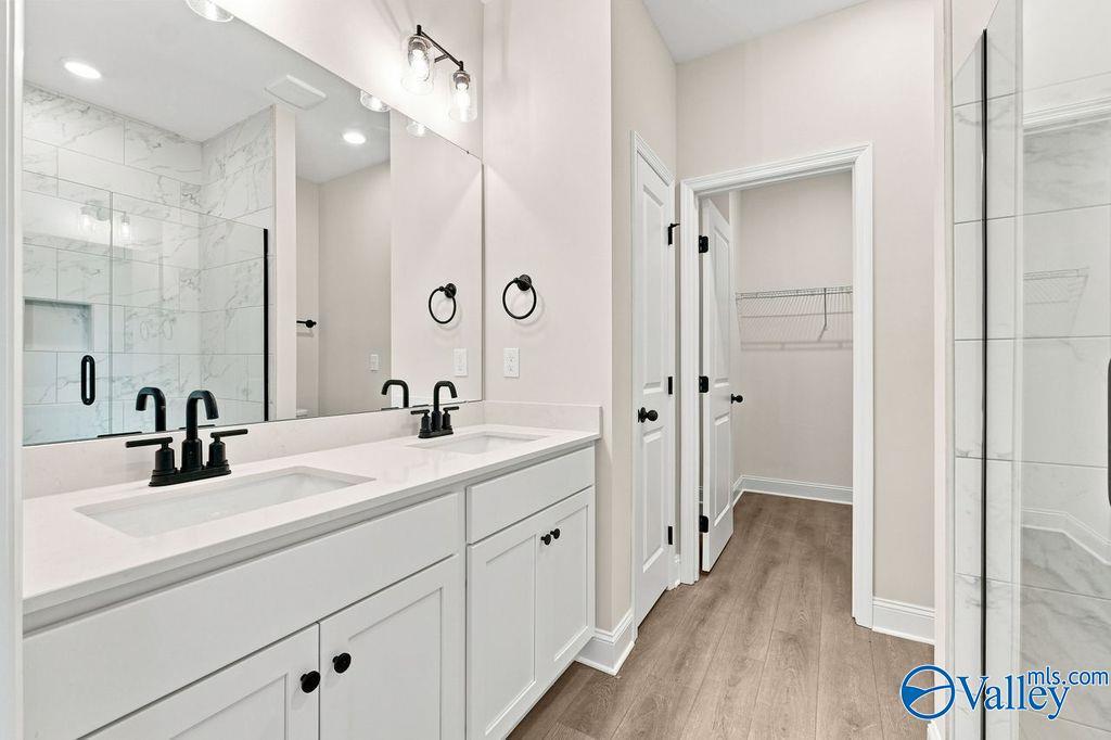 Modern double vanity bathroom with walk-in closet in The Camilla B floor plan at The Retreat at Cain Park, Hartselle, AL.