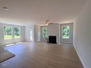 Spacious open-concept living room with fireplace in The Daphne D floor plan at Woodland Crossing, Zebulon, North Carolina.