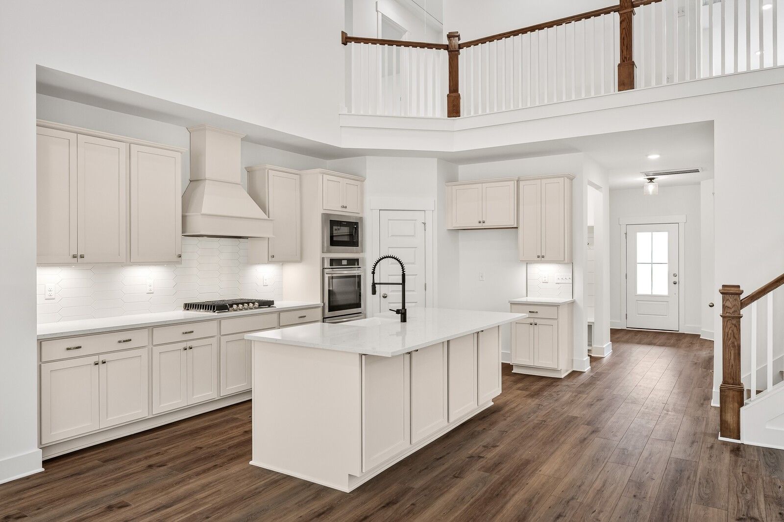 Modern open-concept kitchen with white shaker cabinets, large island, stainless appliances in Davidson Homes Ridgeport C, Gallatin TN