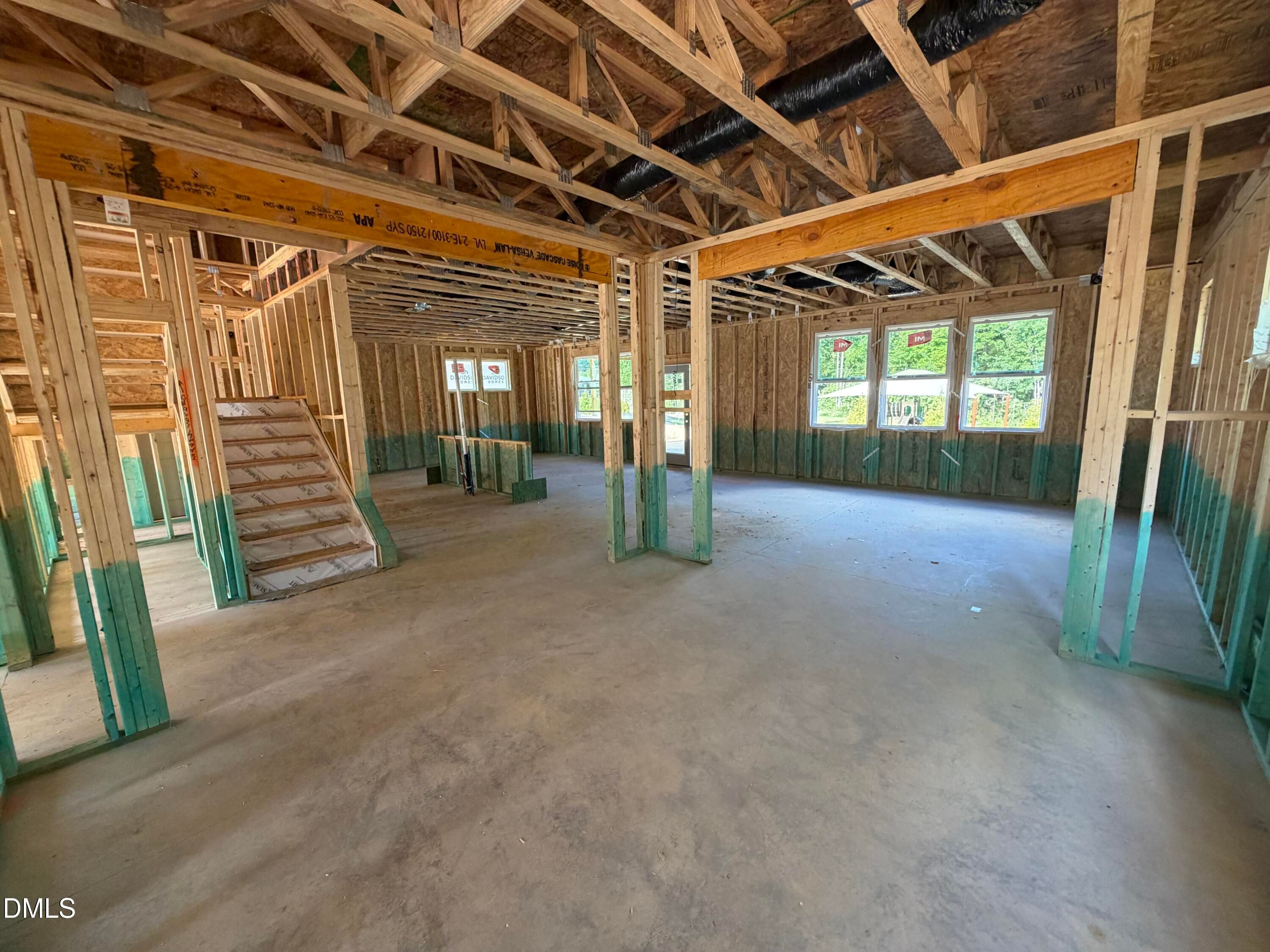 Framed open-concept main living area and staircase under construction in Davidson Homes' The Beech at Wendell Ridge, Wendell, NC