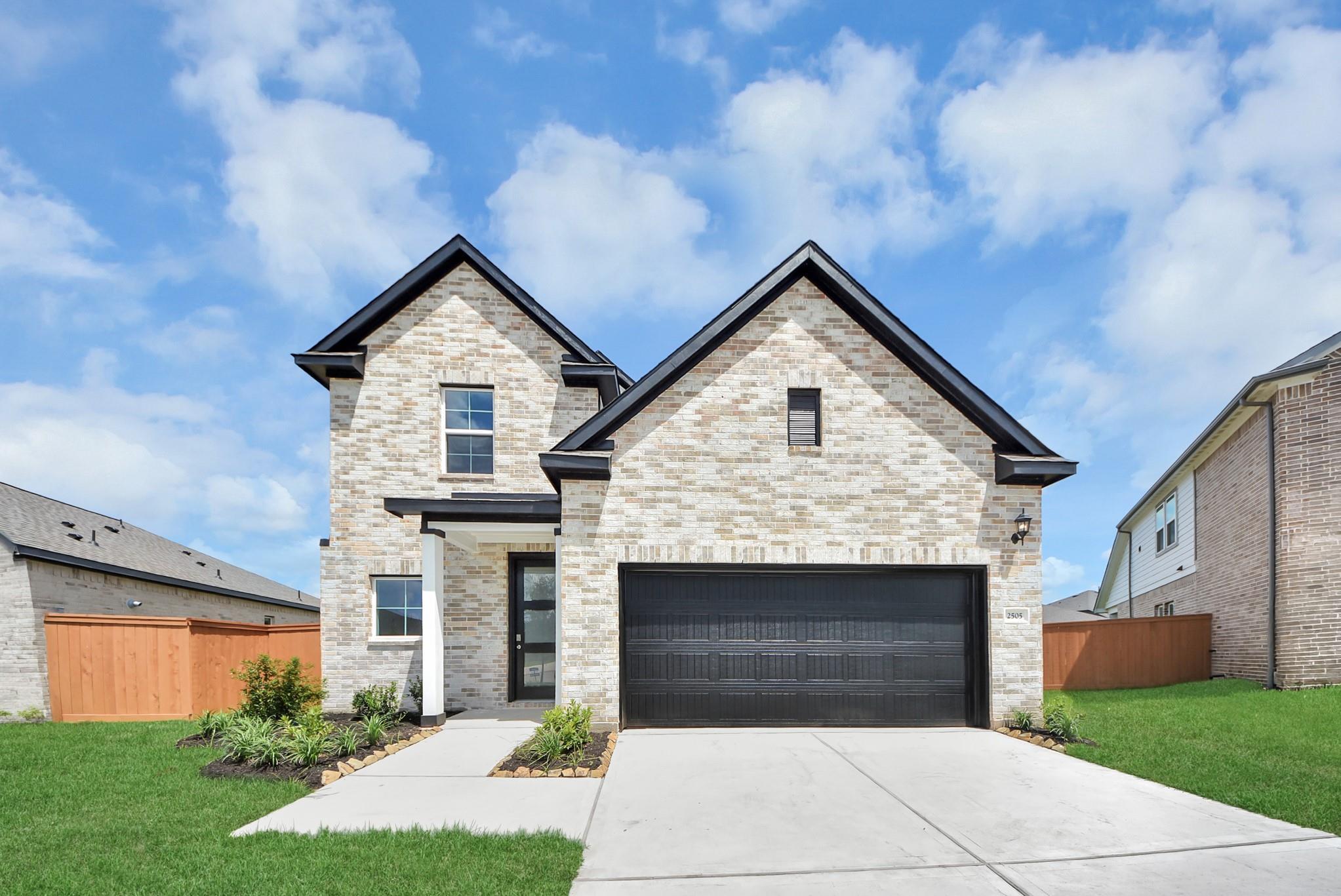 Two-story Davidson Homes Verano B floor plan with brick exterior and 2-car garage in Sunterra, Katy, Texas.