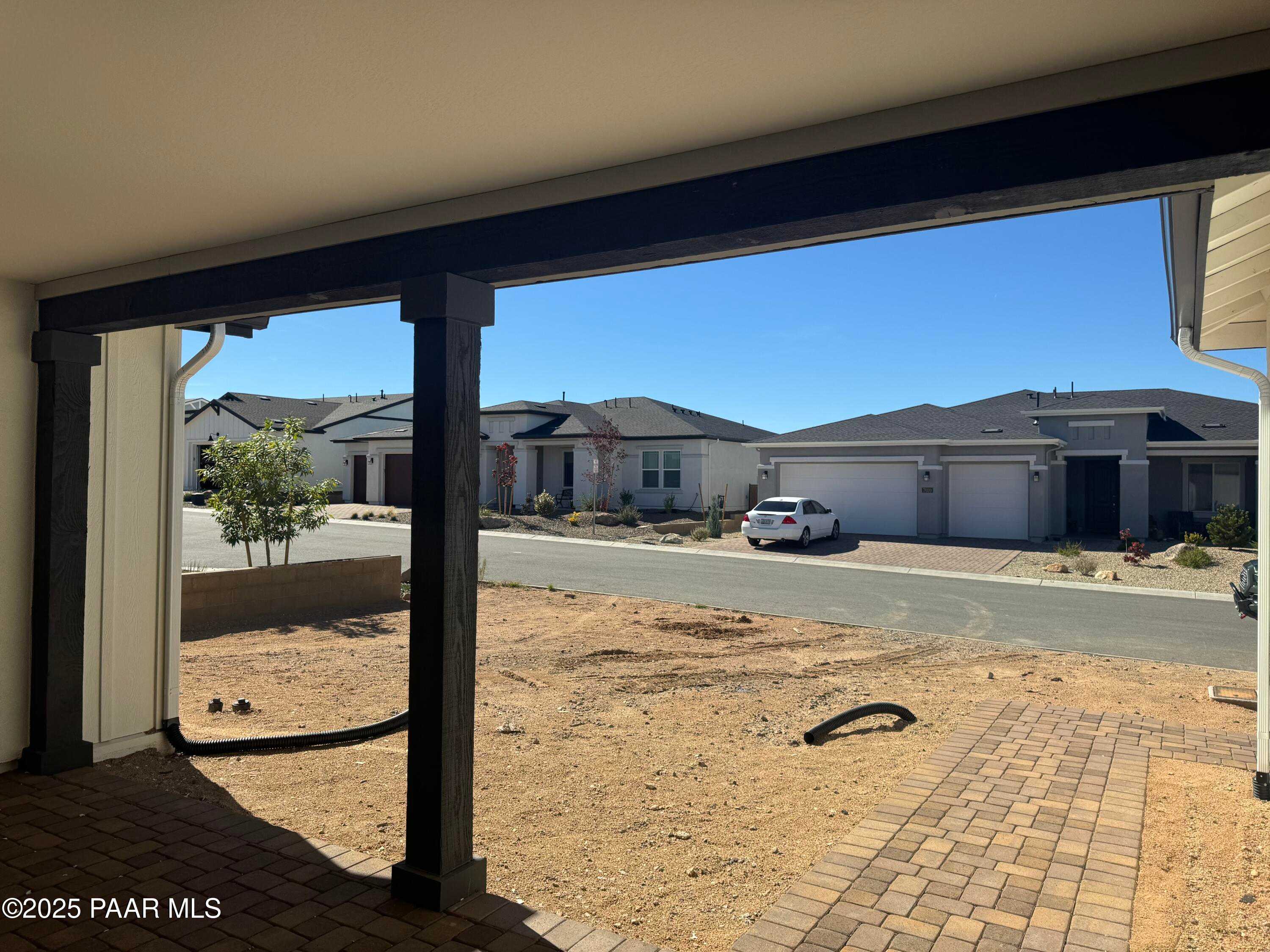 Wide-open 3-car garage with wooden beams overlooking Westwood neighborhood homes in Prescott, Arizona - Davidson Homes The Monarch E